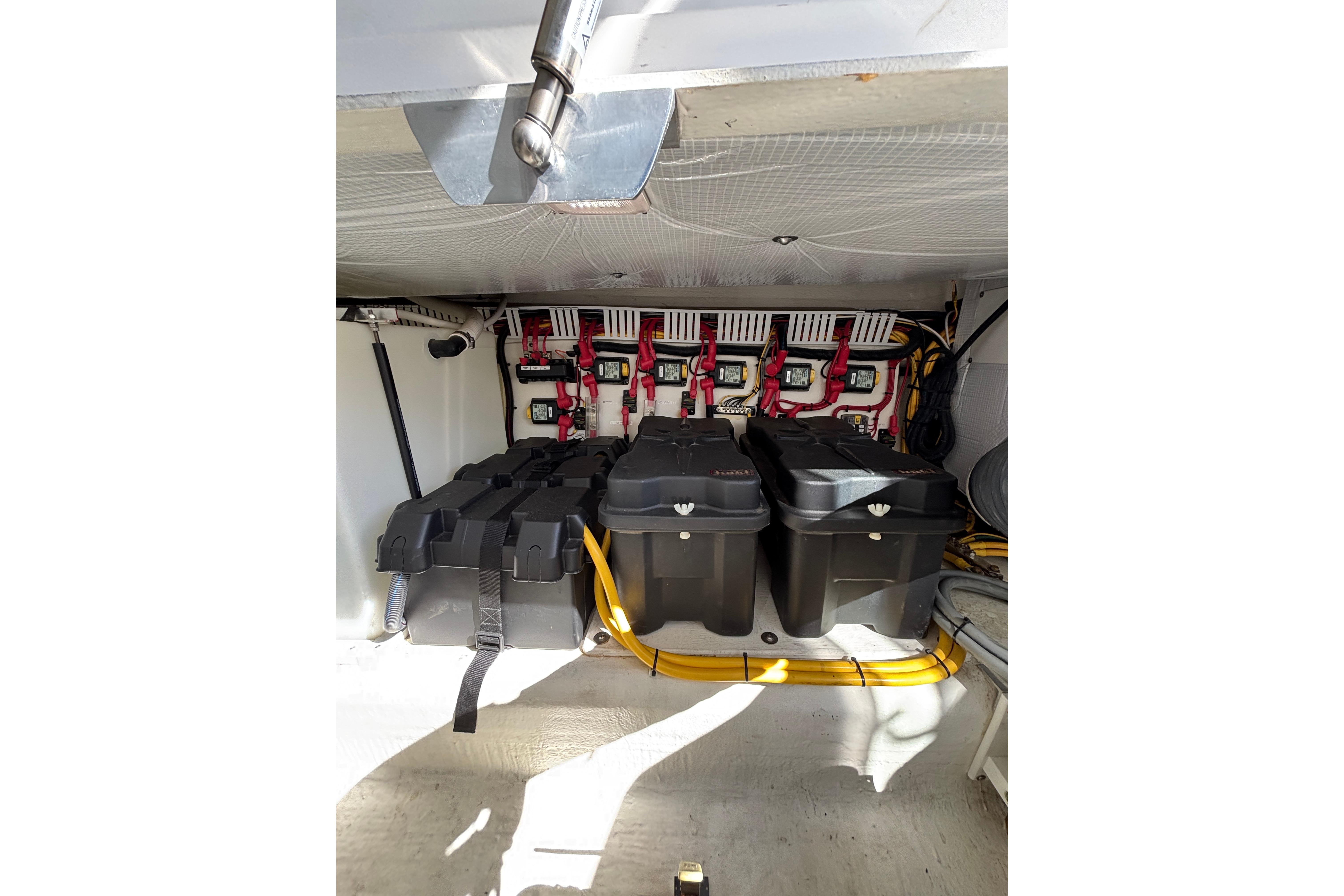Battery compartment of 2020 Back Cove 37 boat with organized wiring and secure battery boxes.