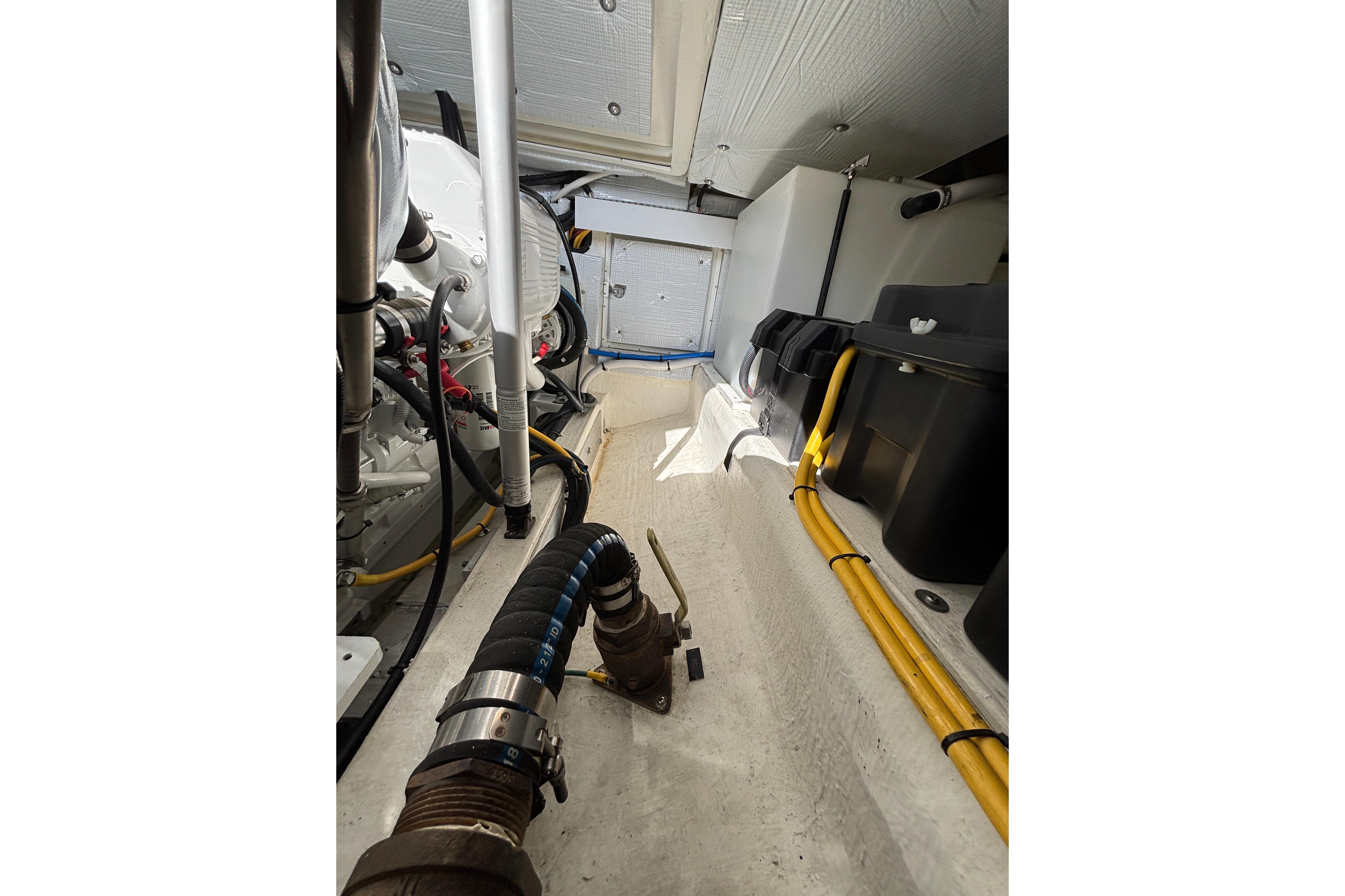 Engine room of 2020 Back Cove 37 boat, showcasing mechanical components and wiring.