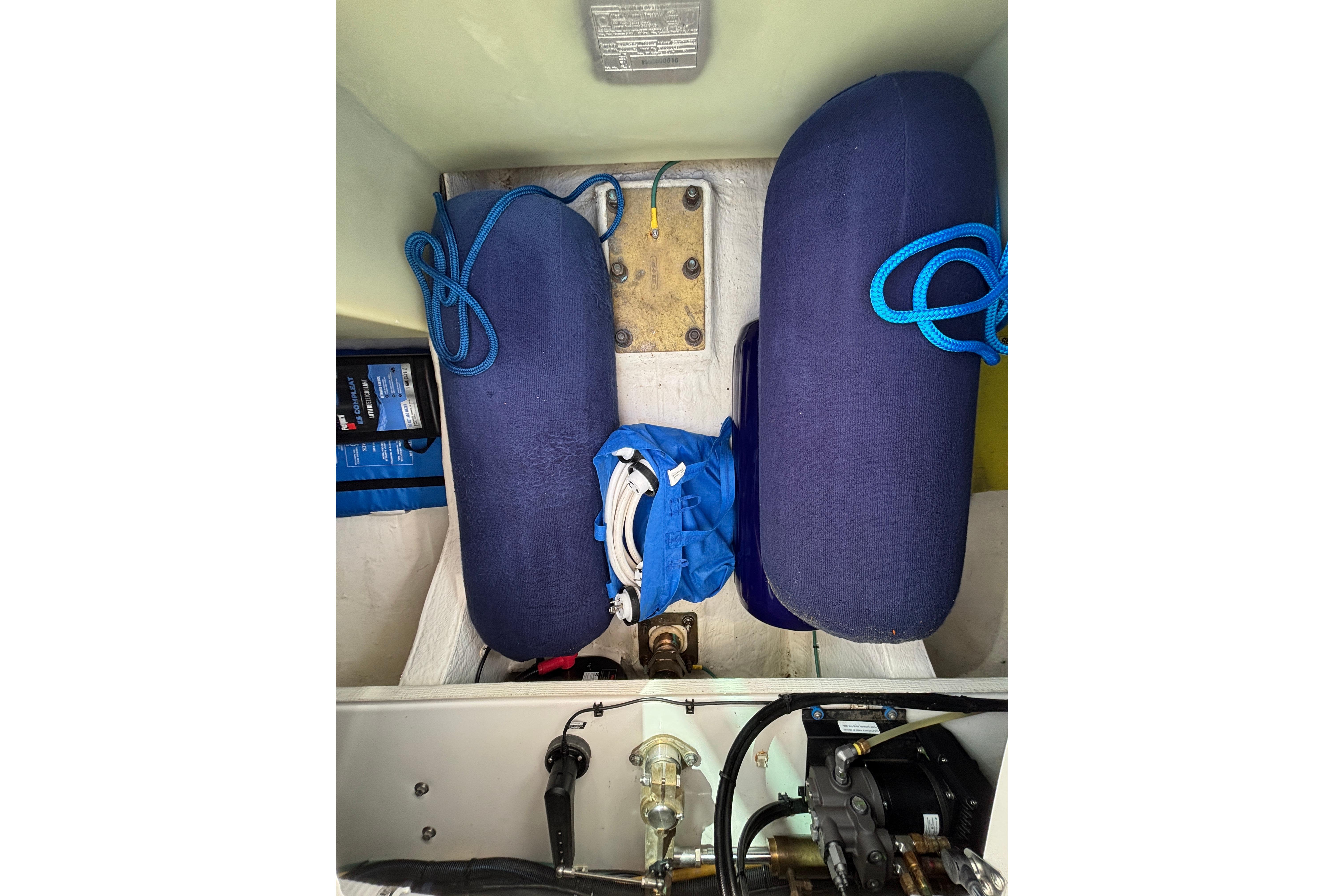Storage compartment of a 2020 Back Cove 37 boat with blue fenders and ropes.