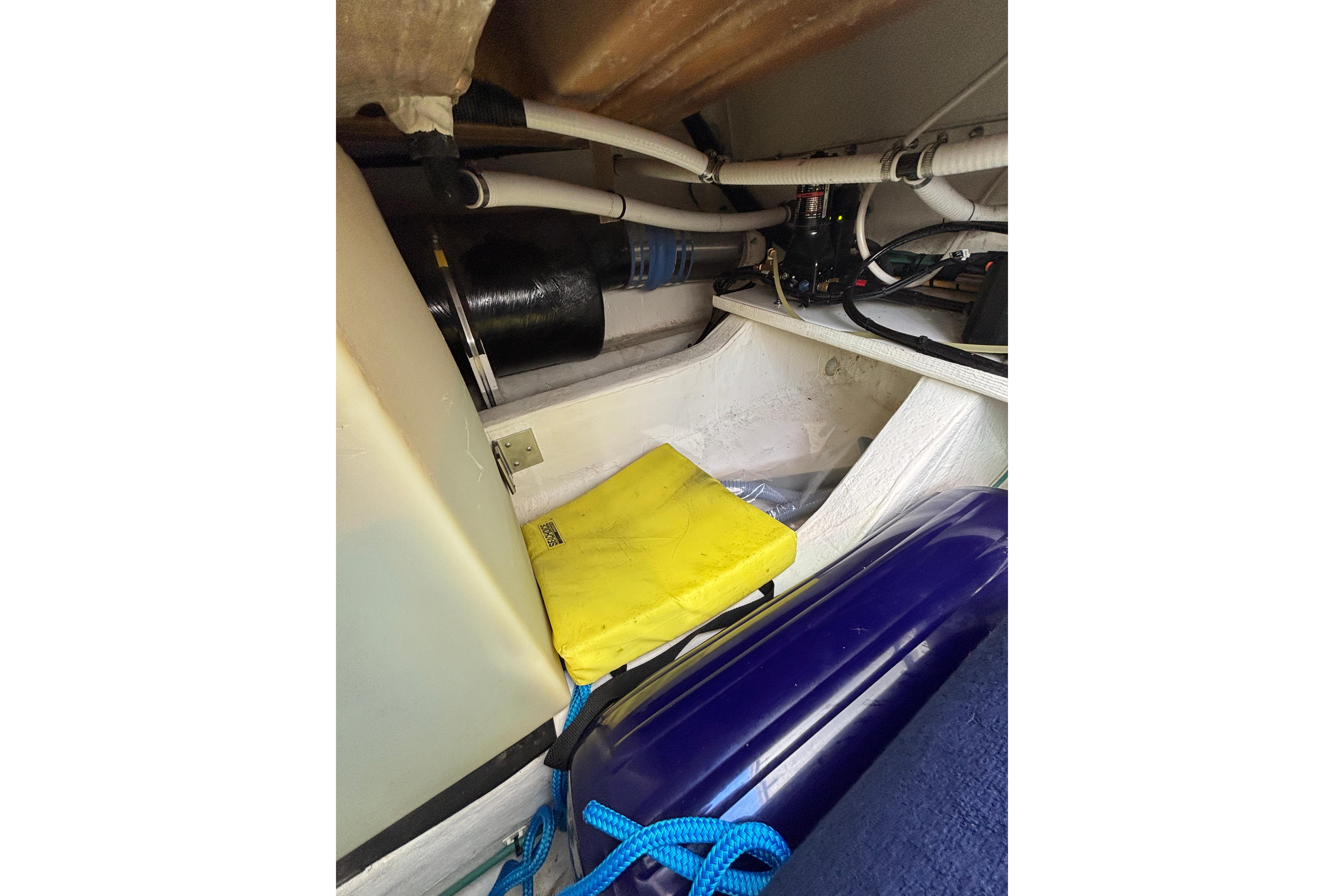 Engine compartment of 2020 Back Cove 37 boat with hoses and equipment.