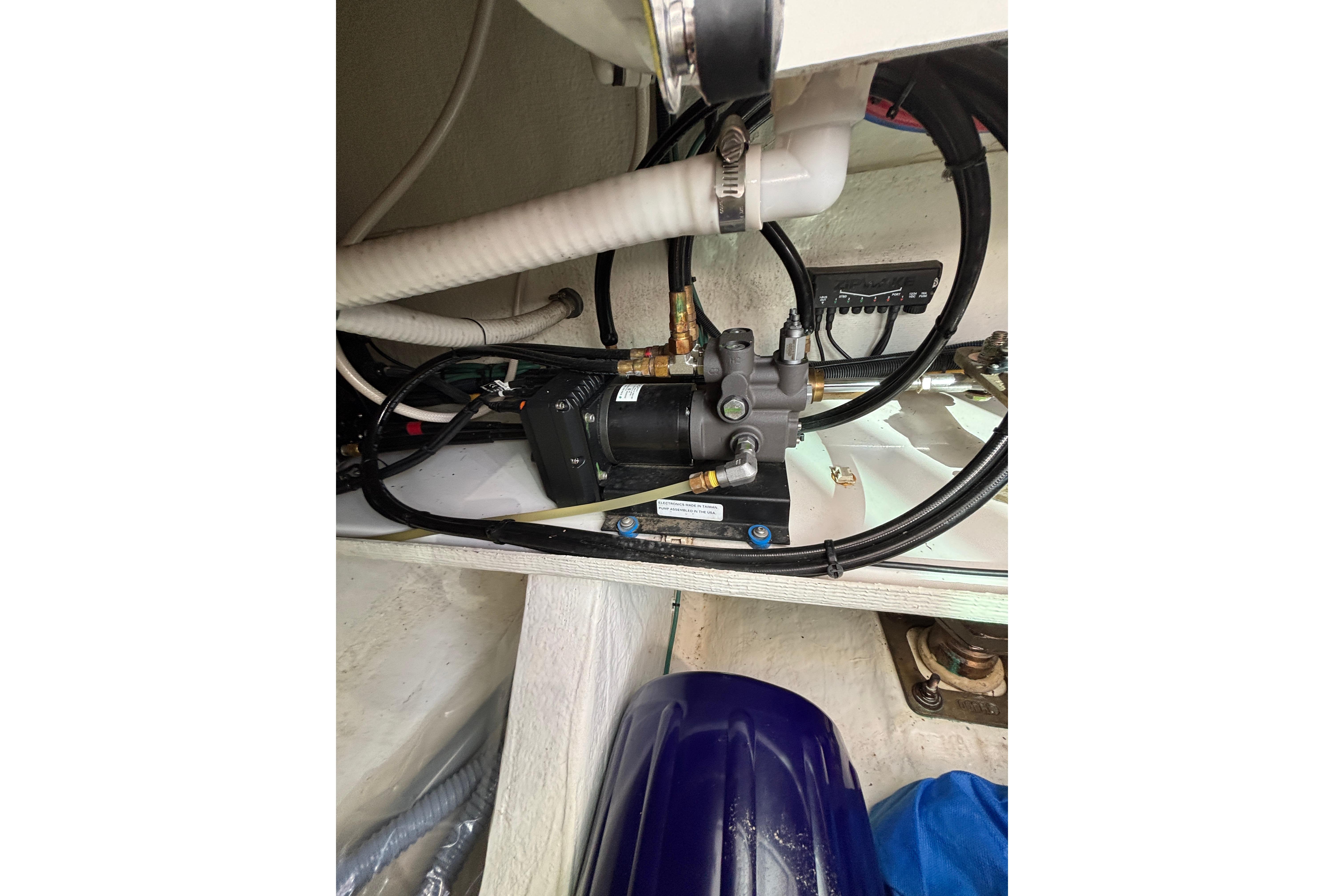Engine compartment of 2020 Back Cove 37 boat, showcasing mechanical components and wiring.