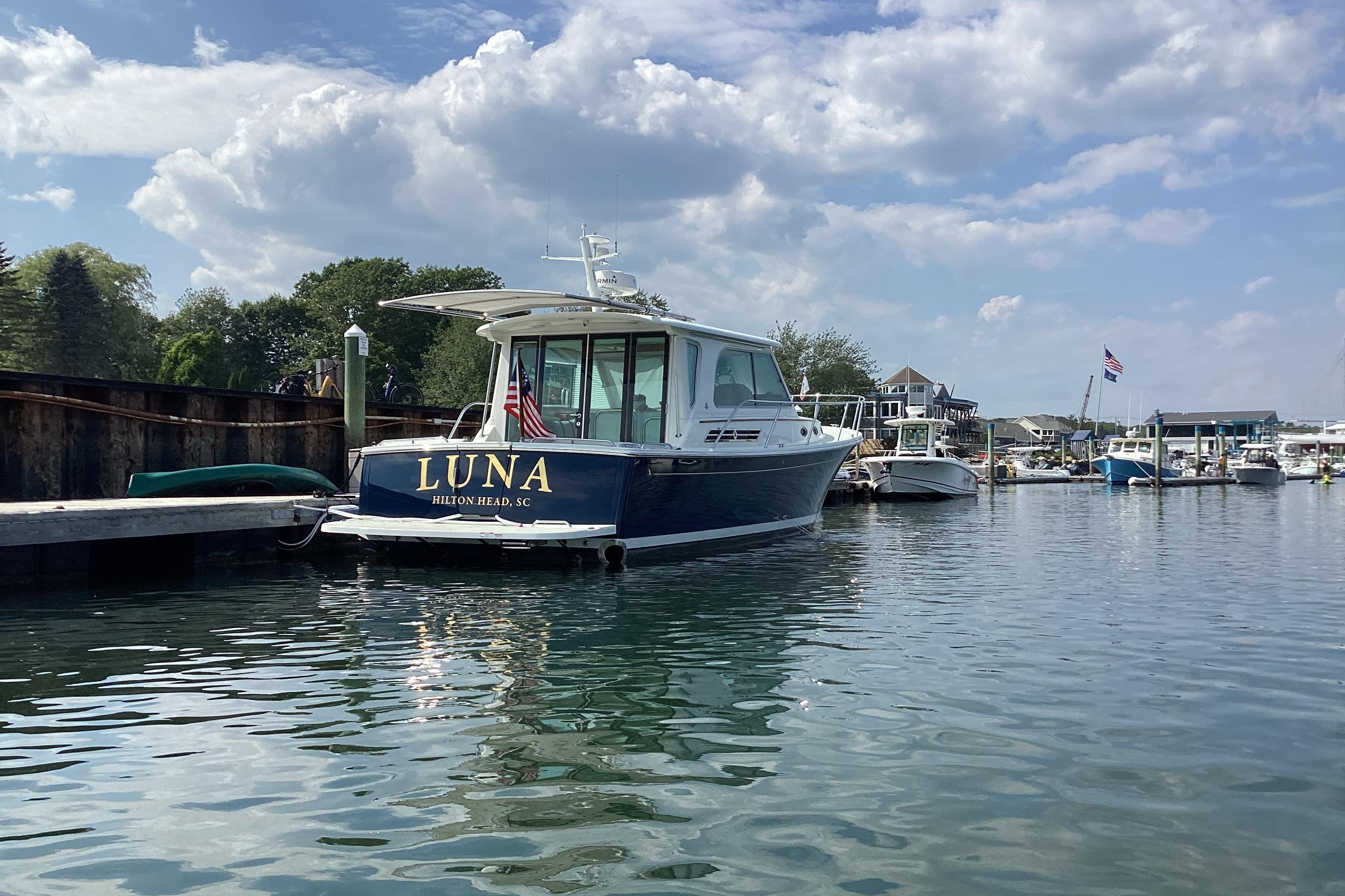 Back Cove 37 boat named u0022Lunau0022 docked in a scenic marina, 2020 model.