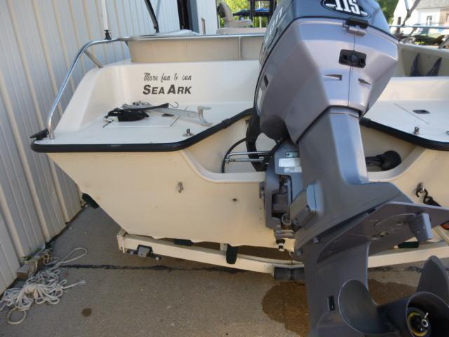 2000 SeaArk Sunstar 21 boat with outboard motor, docked on concrete surface.