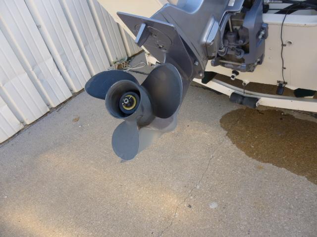 Propeller of a 2000 SeaArk Sunstar 21 boat on concrete surface.
