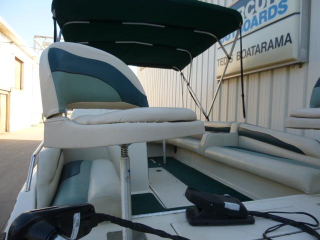 SeaArk Sunstar 21 boat, 2000 model, with green and white seating and canopy.