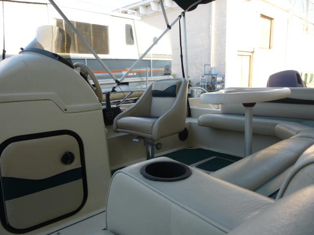 Interior of a 2000 SeaArk Sunstar 21 boat with seating and steering area.