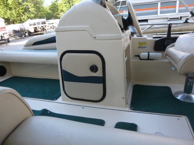 Interior of a 2000 SeaArk Sunstar 21 boat with green carpet and seating.