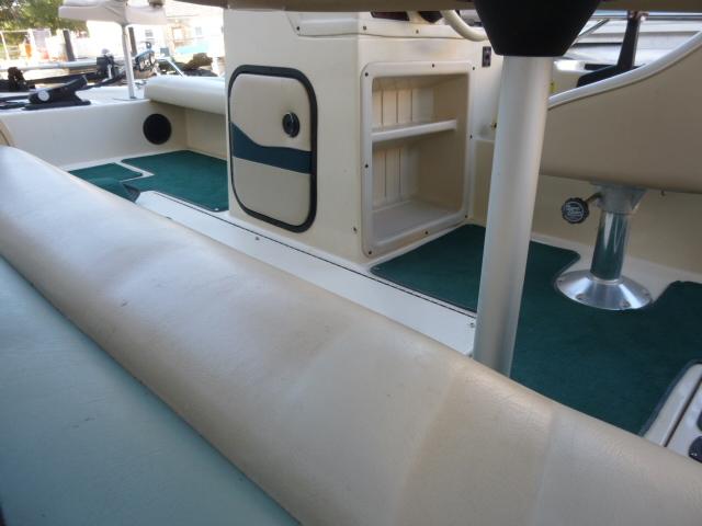 Interior of a 2000 SeaArk Sunstar 21 boat with seating and storage compartments.