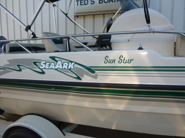 SeaArk Sunstar 21 boat, 2000 model, white with green accents, parked at Ted's Boats.