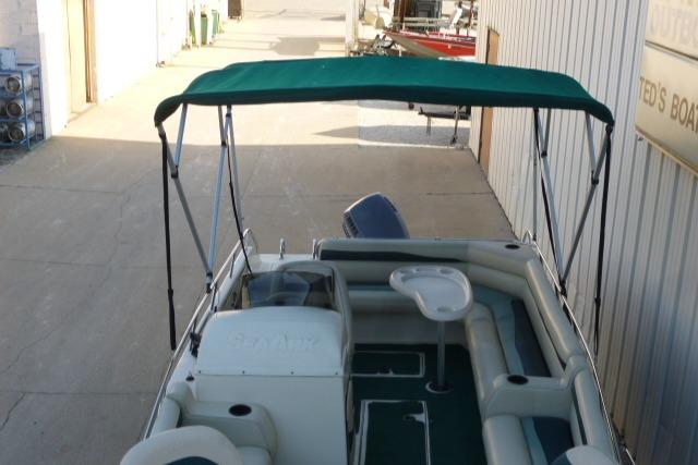SeaArk Sunstar 21 boat, 2000 model, with green canopy and spacious seating.