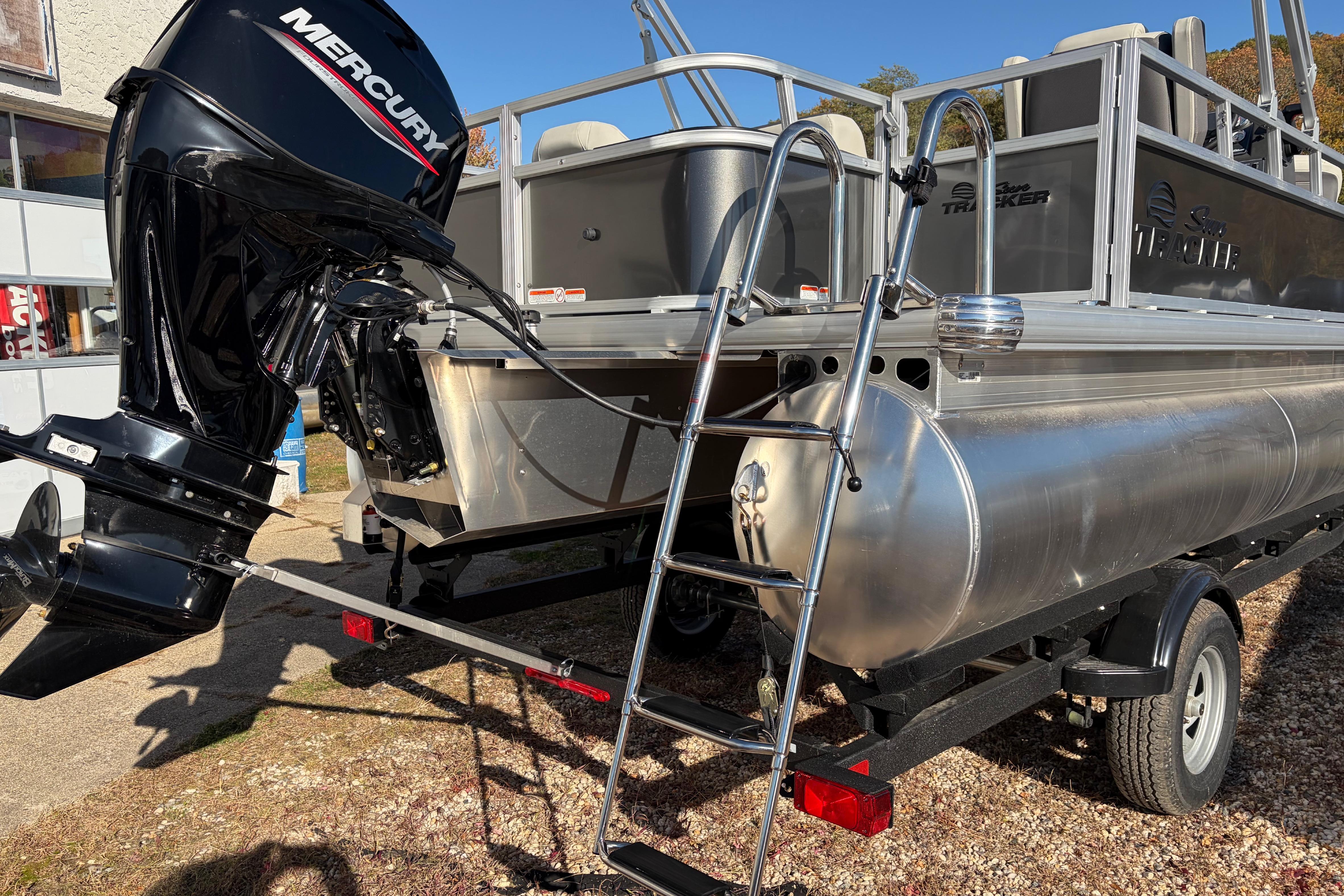 2026 Sun Tracker Bass Buggy 18 DLX pontoon boat with Mercury outboard motor and ladder.