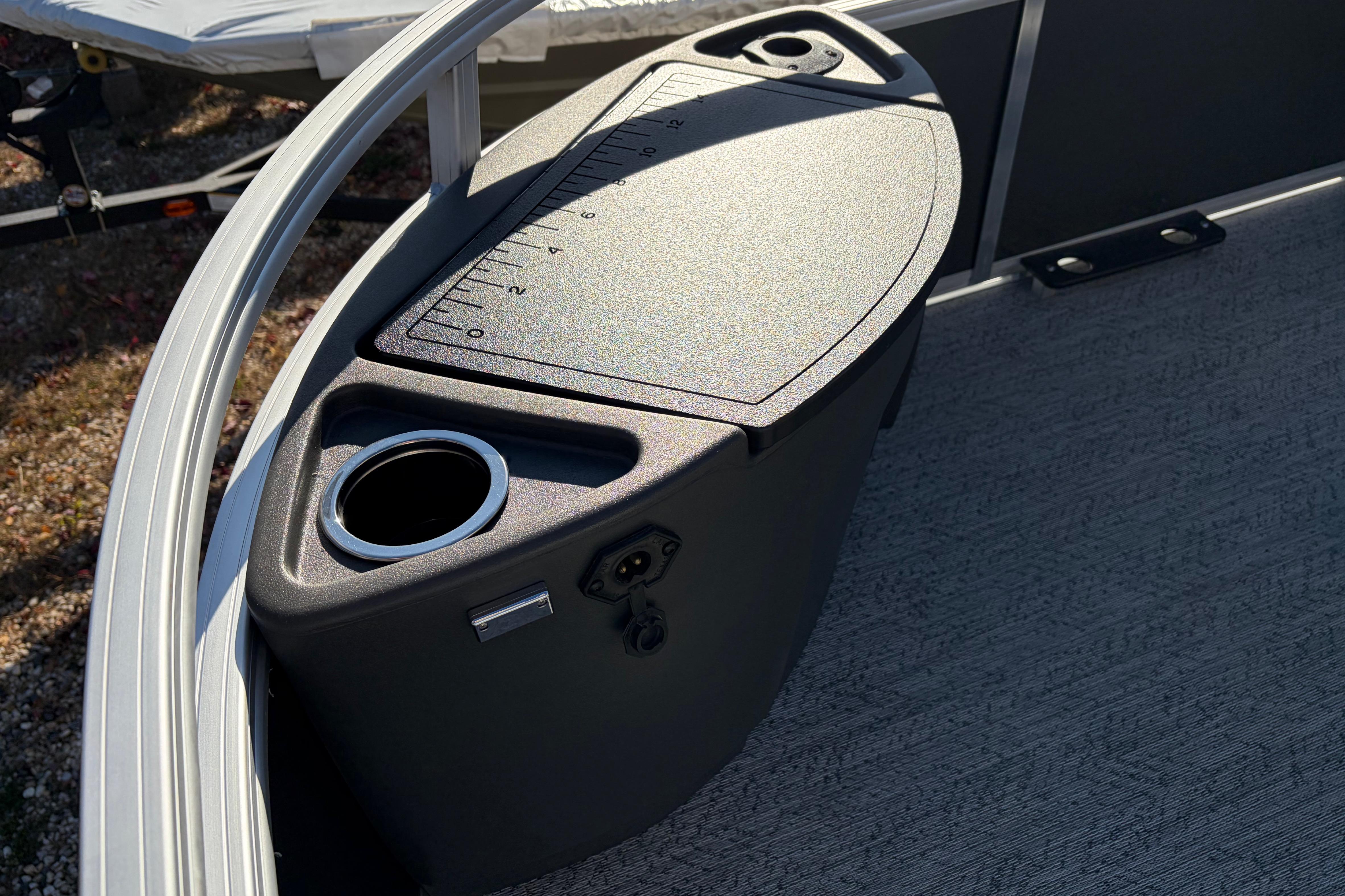 2026 Sun Tracker Bass Buggy 18 DLX boat console with cup holder and measurement markings.