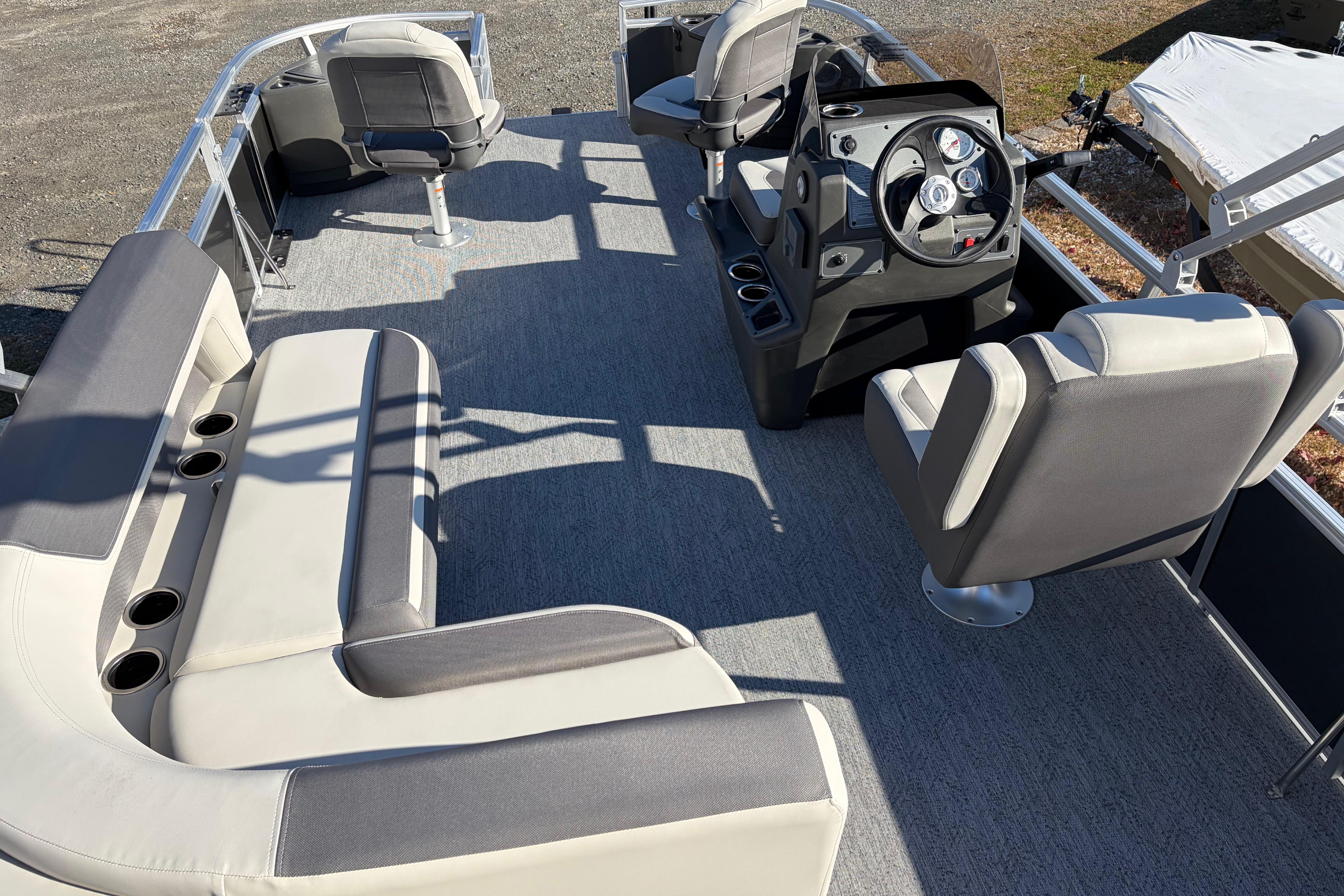 2026 Sun Tracker Bass Buggy 18 DLX pontoon boat interior with seating and helm.