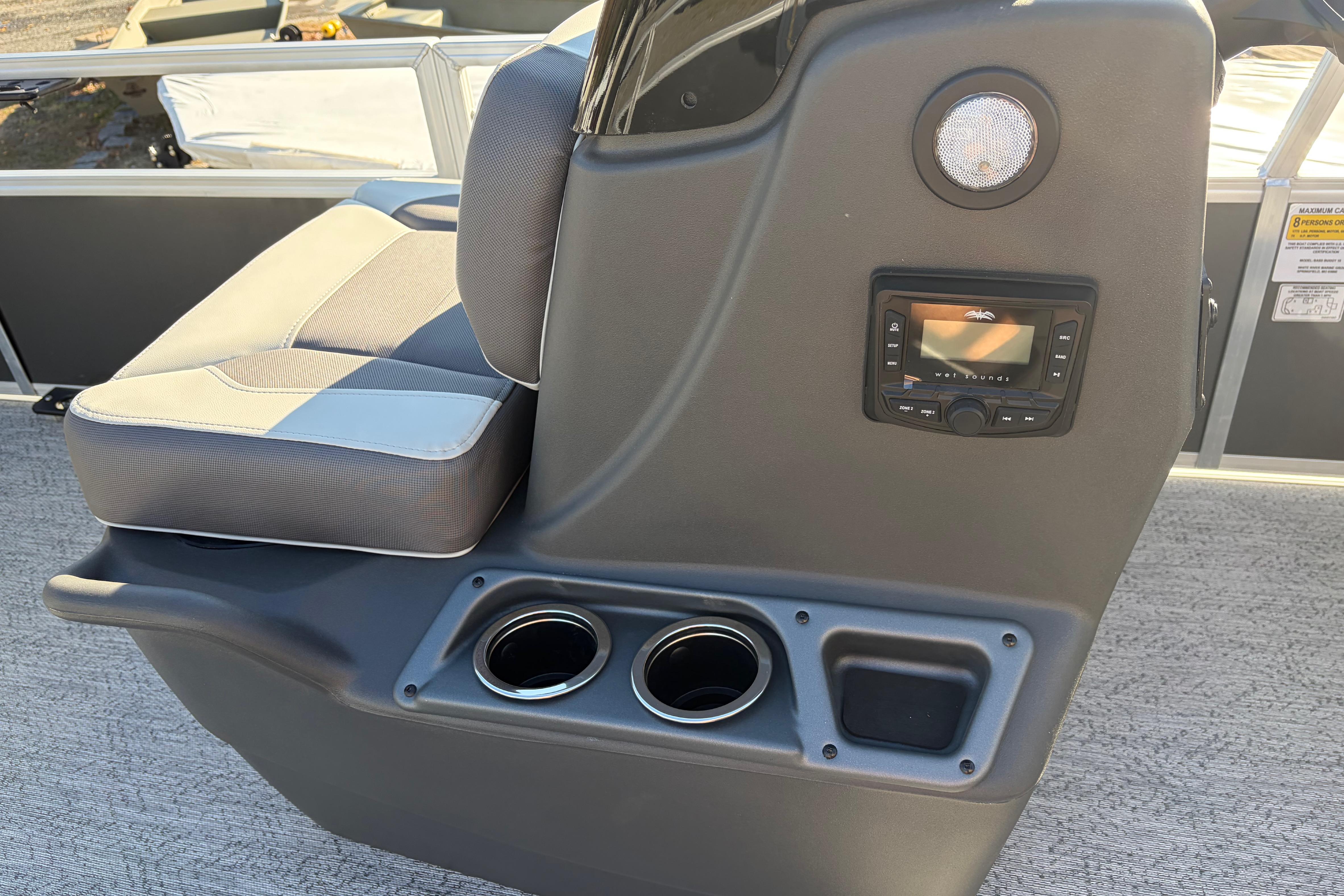 2026 Sun Tracker Bass Buggy 18 DLX console with seating, cup holders, and audio controls.