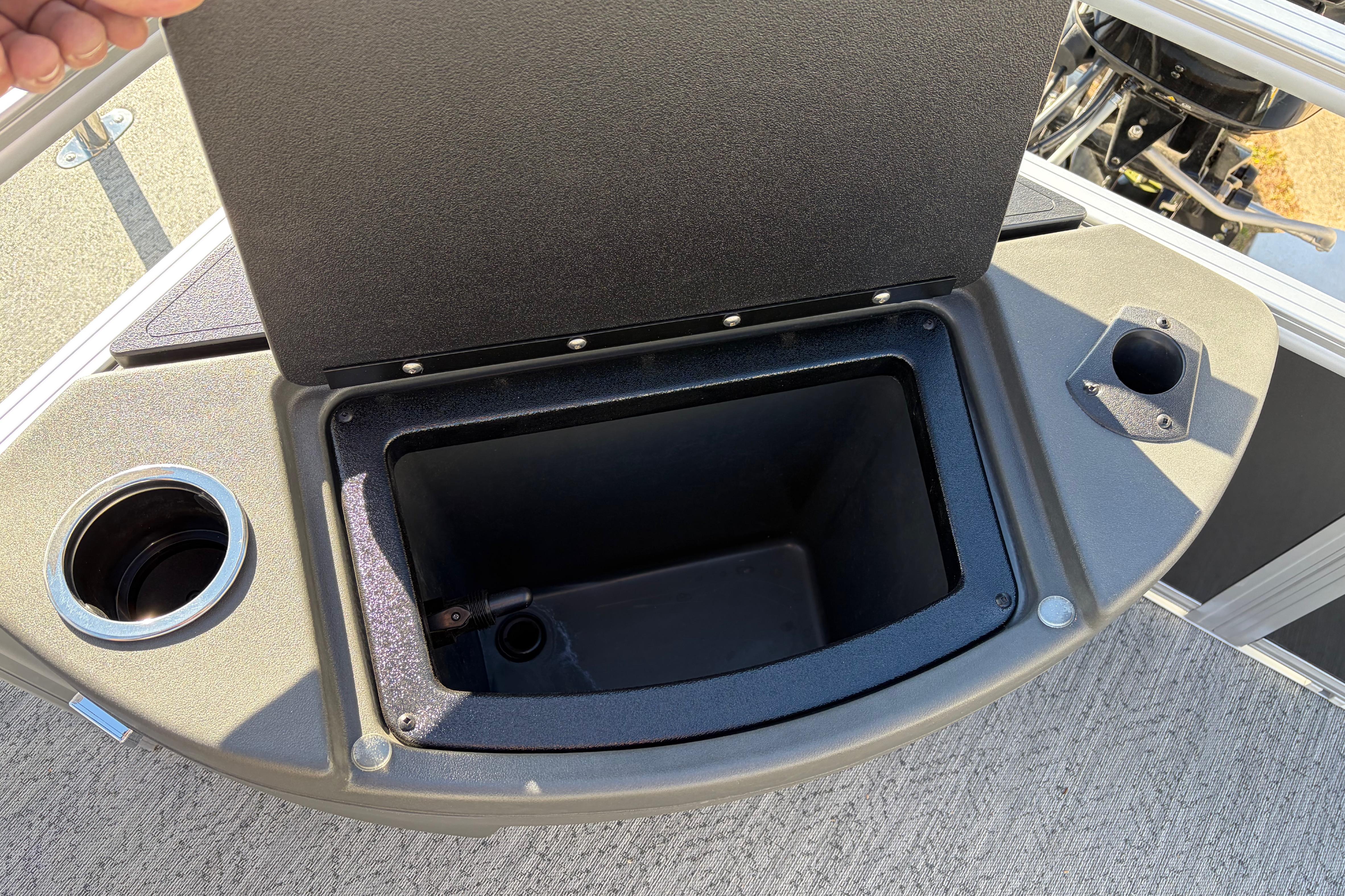 2026 Sun Tracker Bass Buggy 18 DLX storage compartment with cup holders on deck.