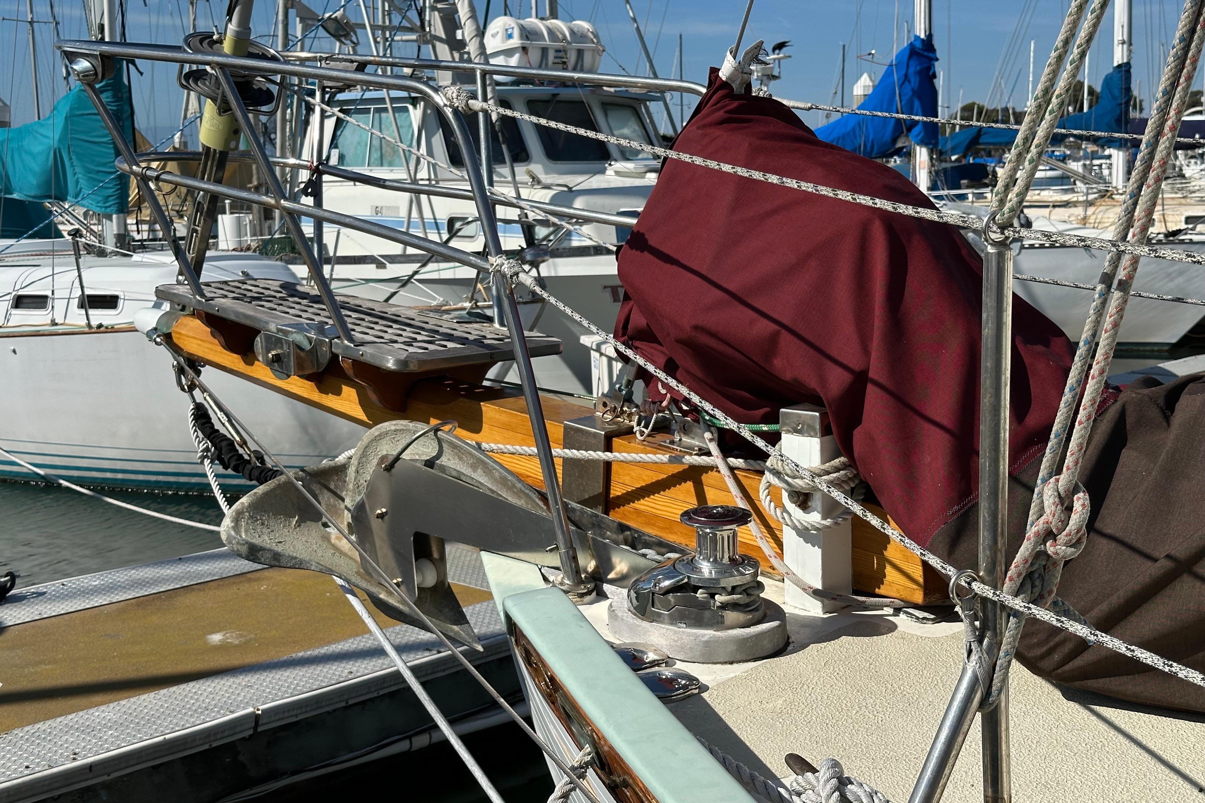1978 Tayana 37 sailboat bow with anchor and rigging at marina.