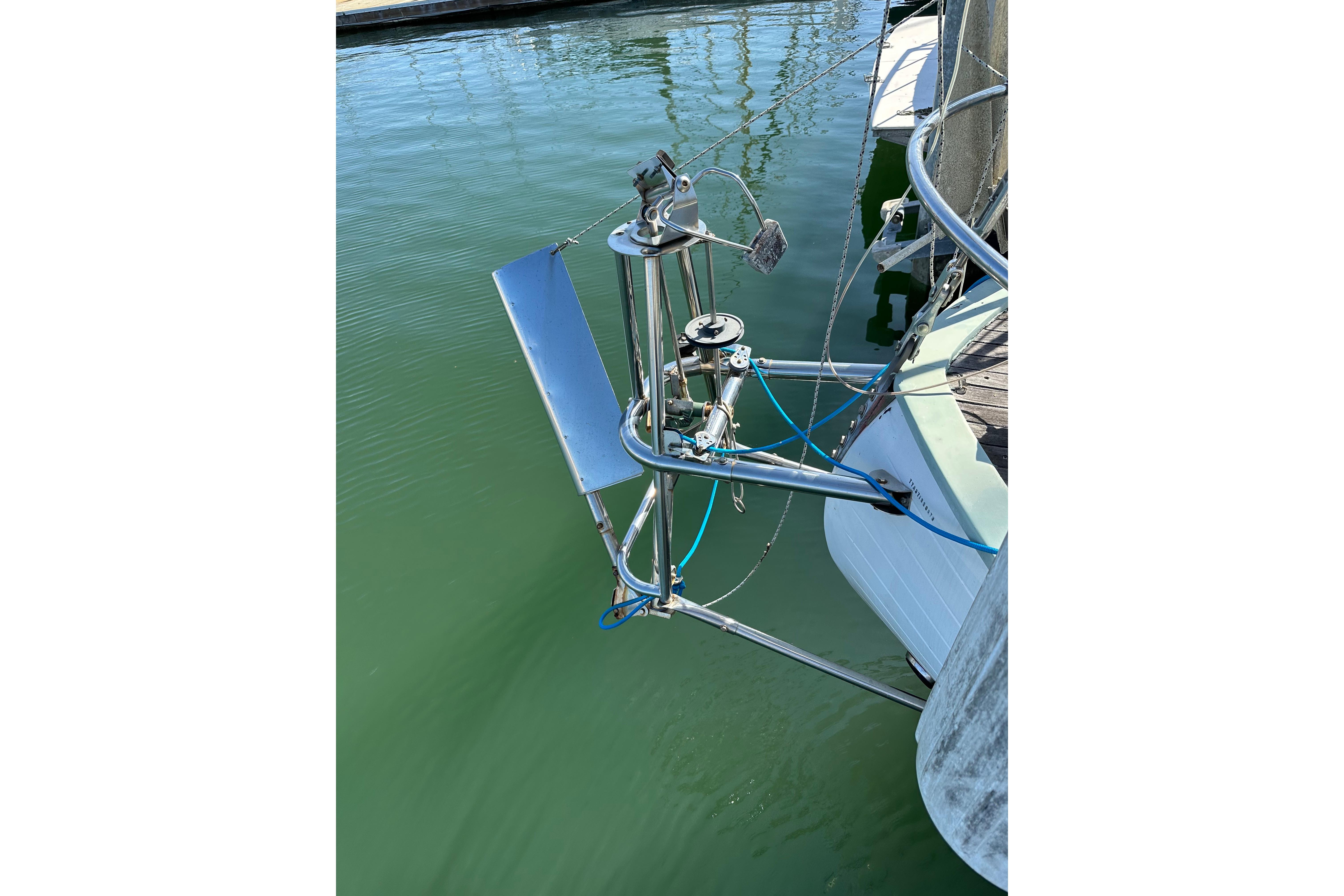 1978 Tayana 37 sailboat with stainless steel wind vane in marina.