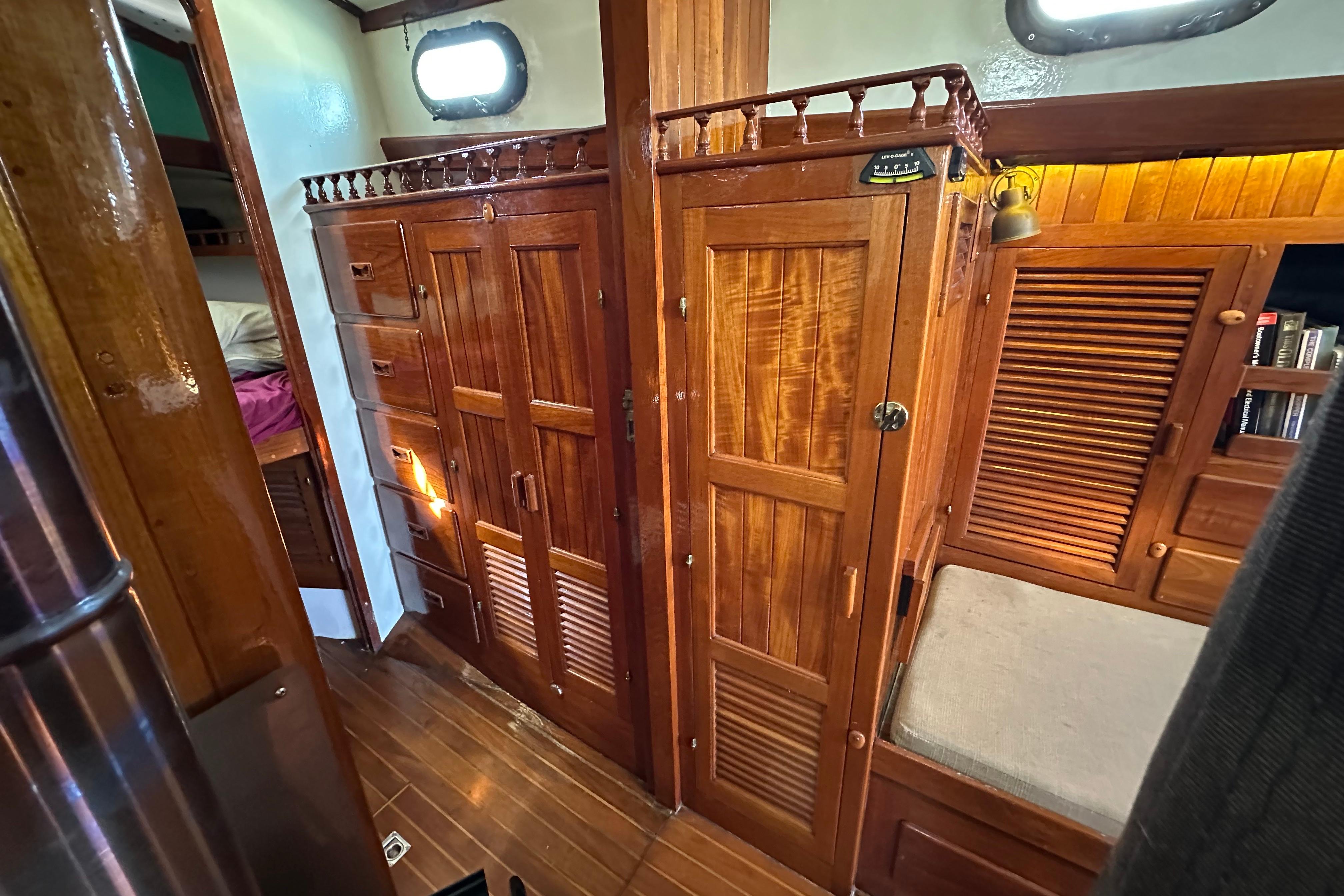 Interior of 1978 Tayana 37 sailboat with wooden cabinetry and cozy seating area.