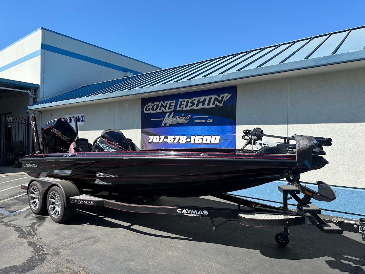 2024 Caymas XS 20 boat on trailer outside dealership, showcasing sleek design.