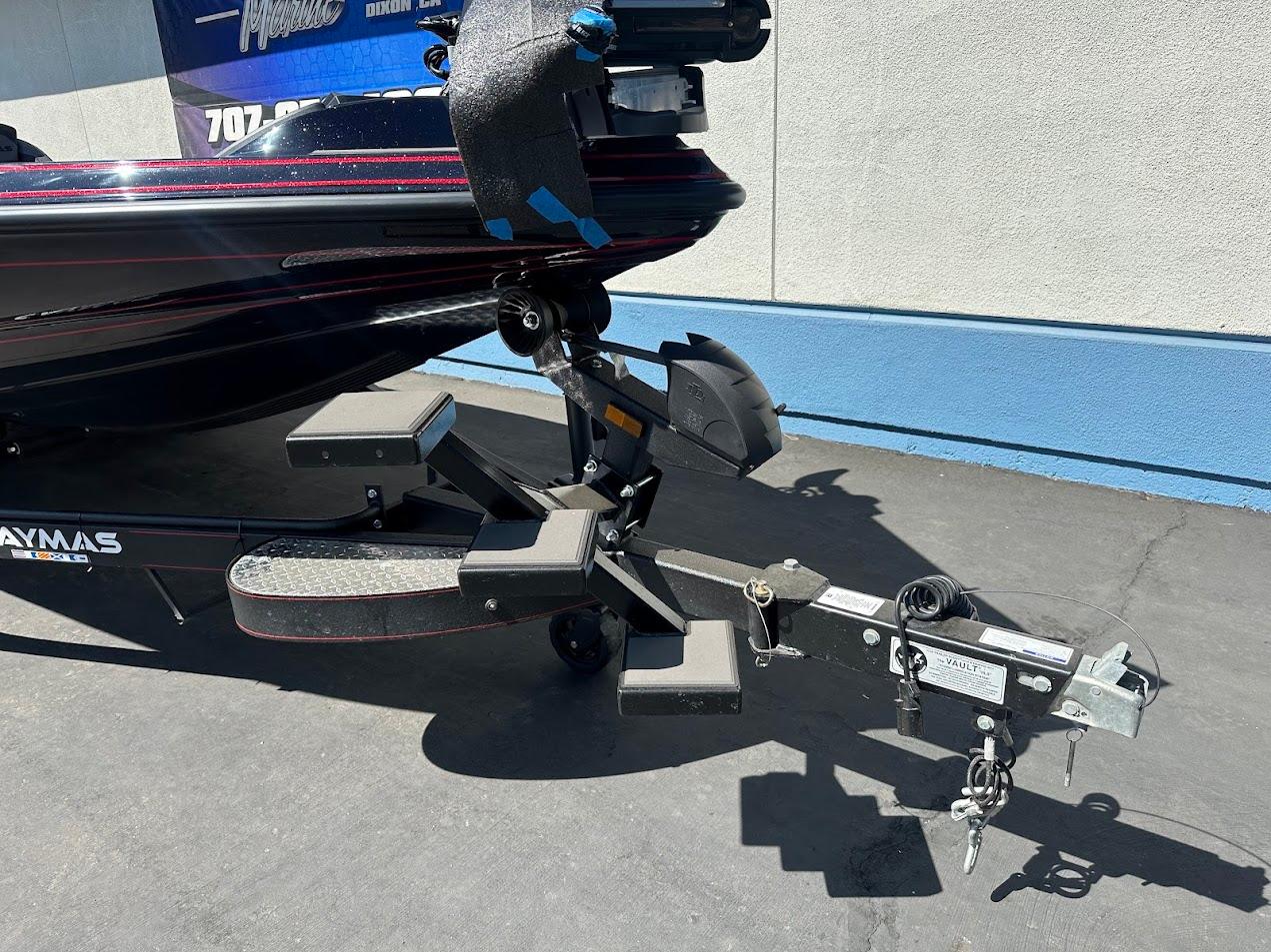 2024 Caymas XS 20 boat trailer hitch and steps, parked on pavement.