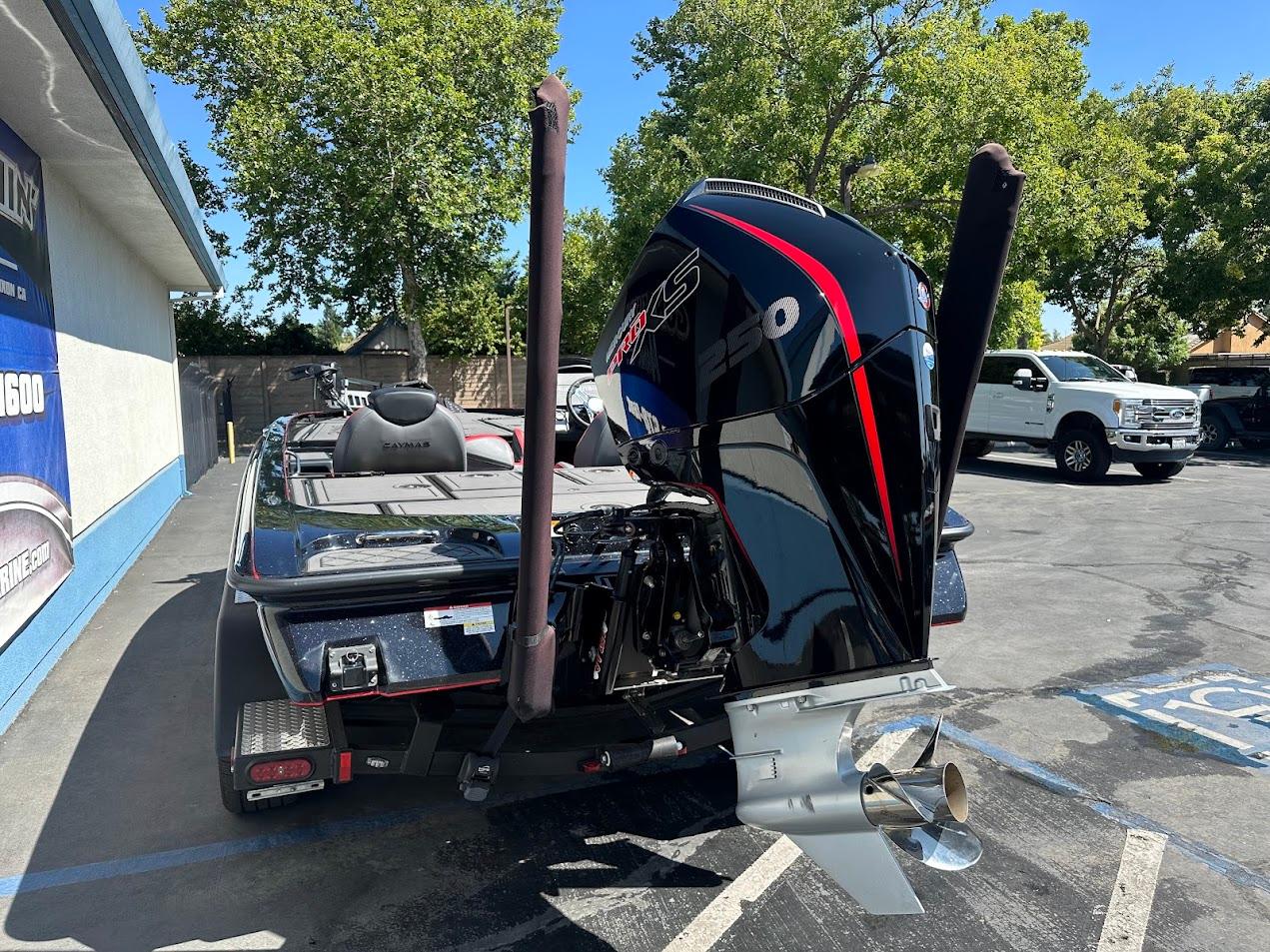 2024 Caymas XS 20 boat with powerful outboard motor in a parking lot.