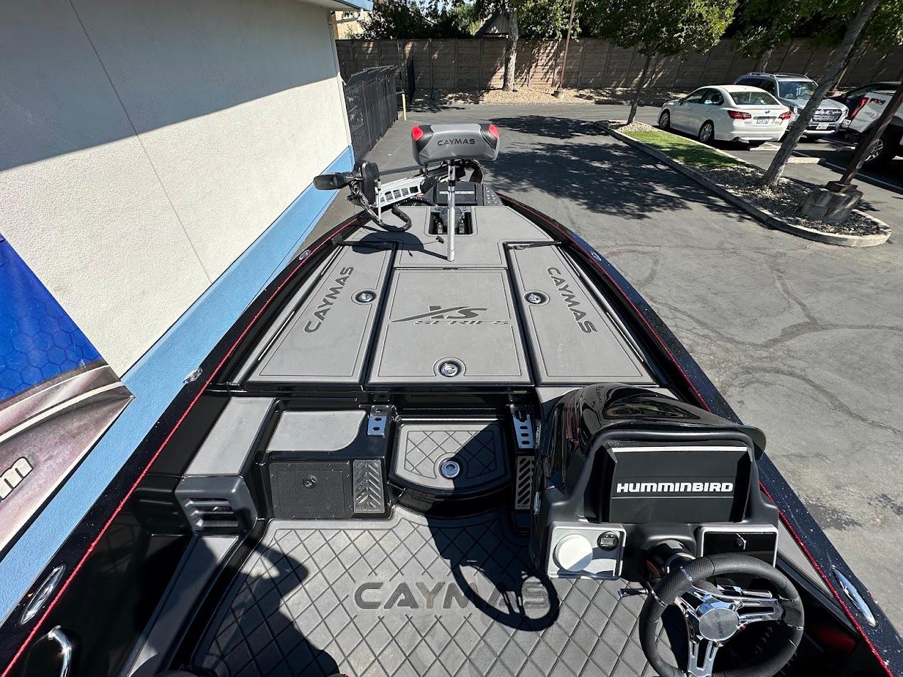 2024 Caymas XS 20 boat interior with Humminbird electronics and steering wheel, parked outdoors.