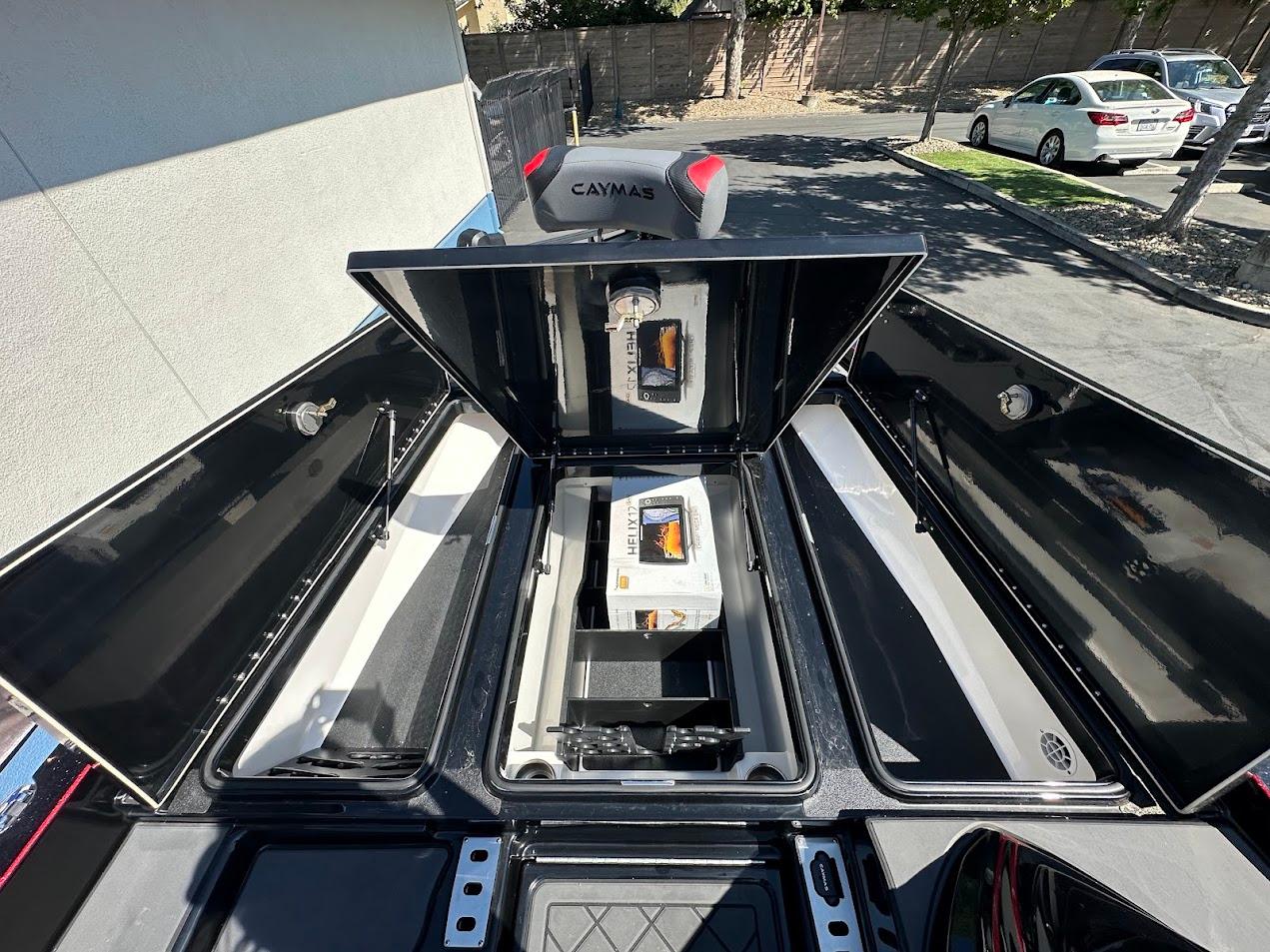 2024 Caymas XS 20 boat storage compartments open, showcasing interior layout and design.
