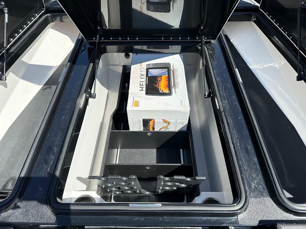 2024 Caymas XS 20 boat storage compartment with electronic equipment box inside.