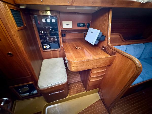 1974 Nautor Swan 38 yacht interior with navigation station and wooden cabinetry.