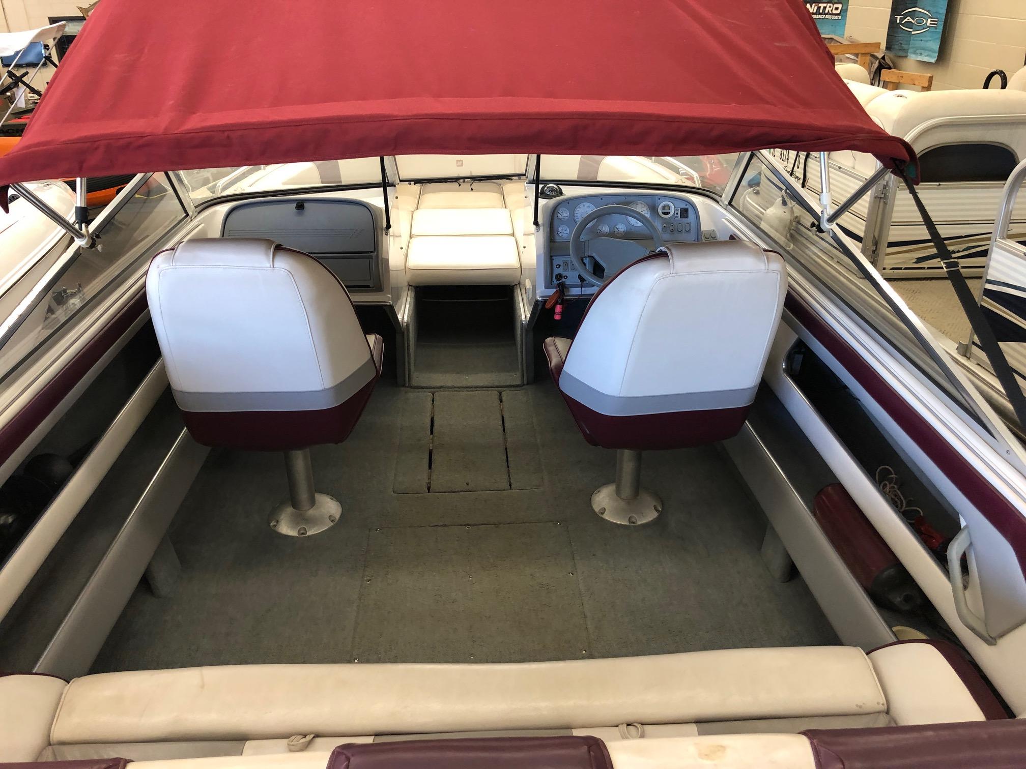 1992 Four Winns 220 Horizon Open Bow boat interior with red canopy and white seats.