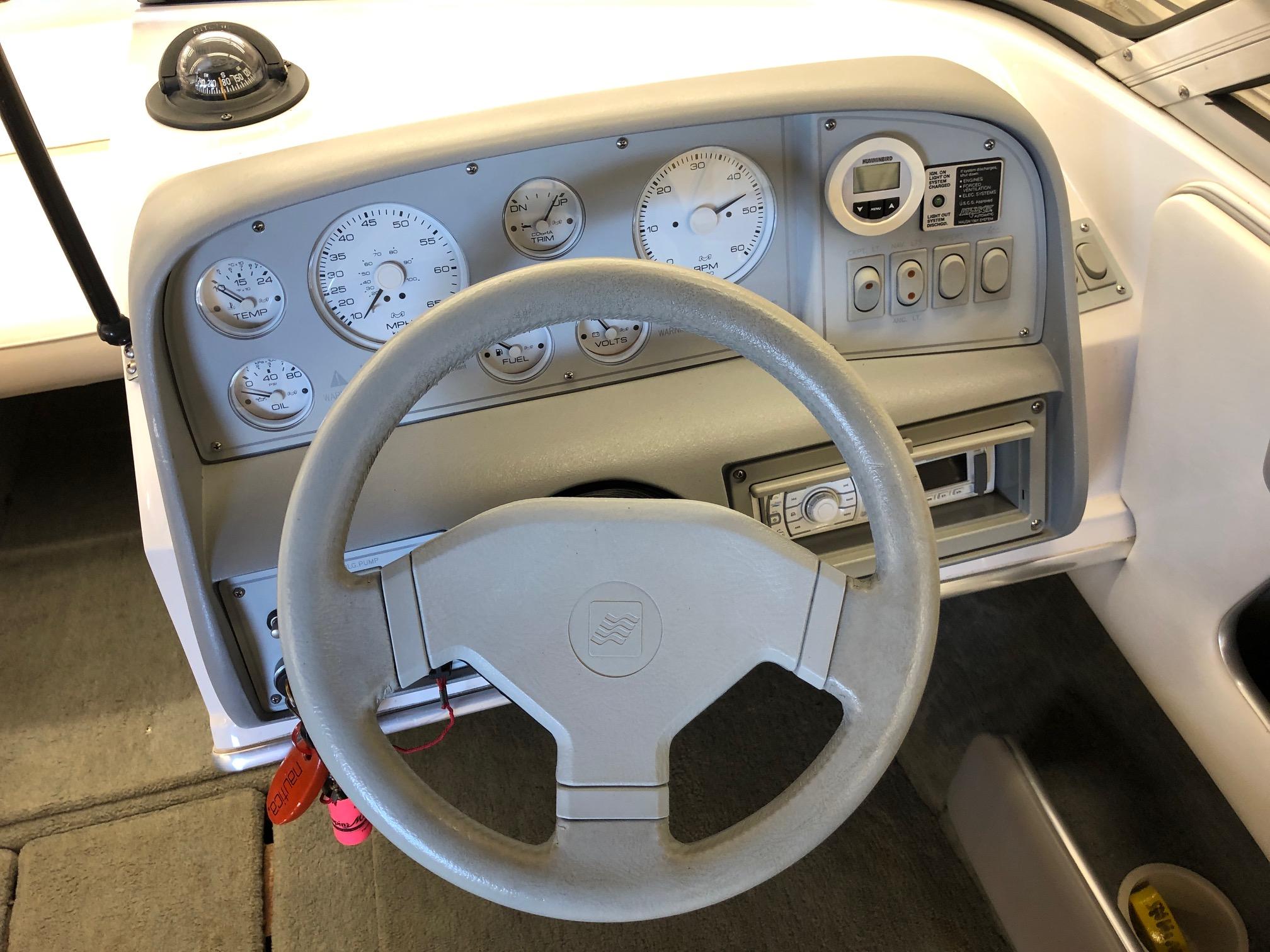 1992 Four Winns 220 Horizon Open Bow boat dashboard with steering wheel and gauges.