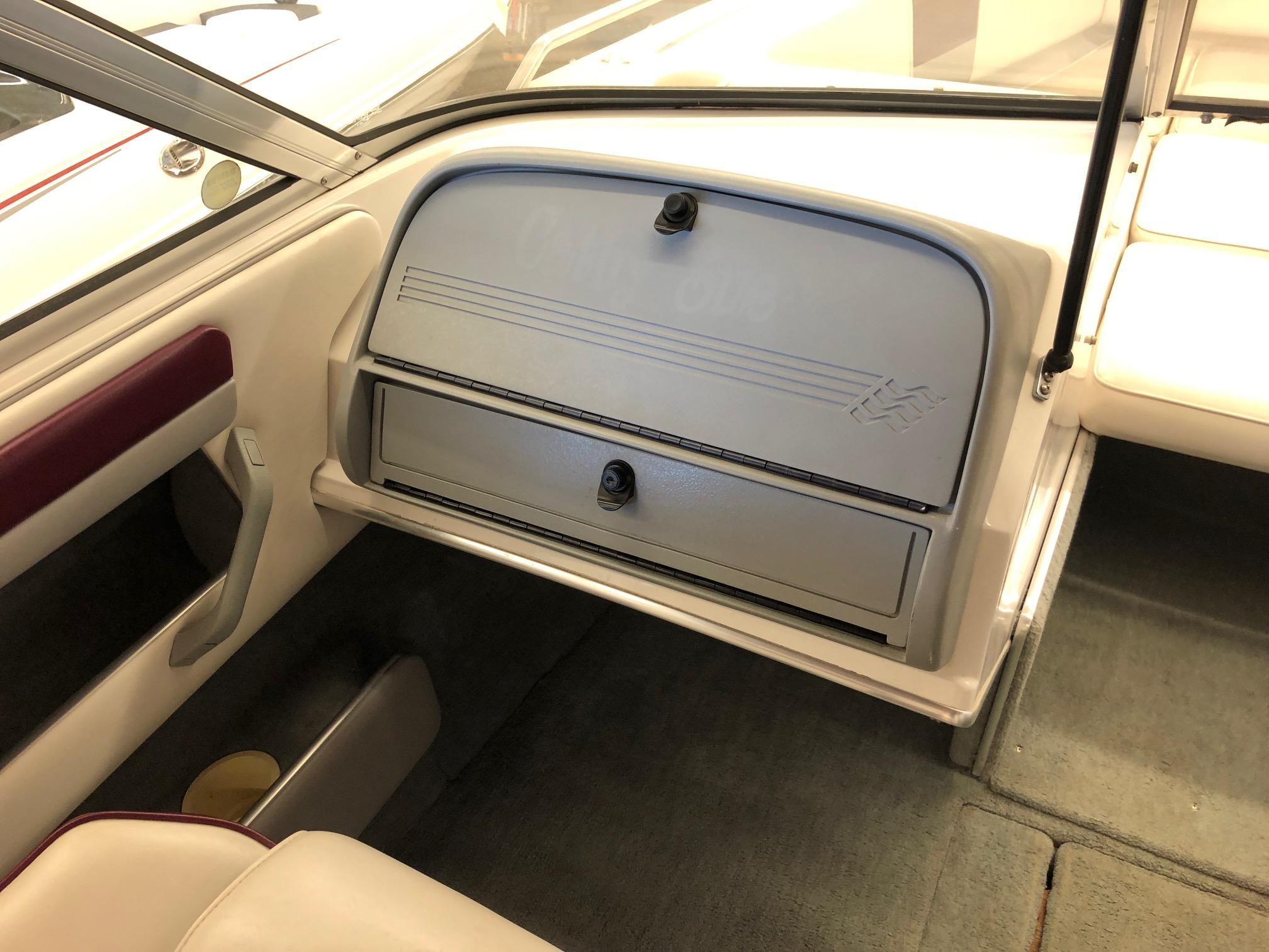 1992 Four Winns 220 Horizon Open Bow boat interior, featuring glove compartment and seating area.