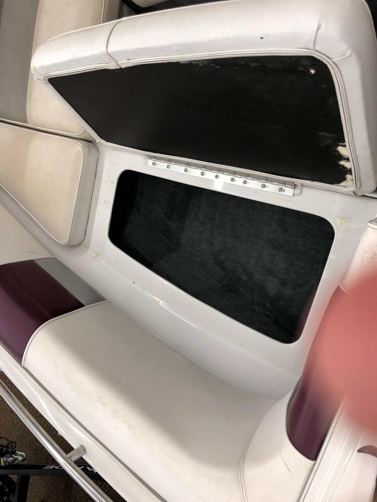 Open storage compartment in a 1992 Four Winns 220 Horizon Open Bow boat.