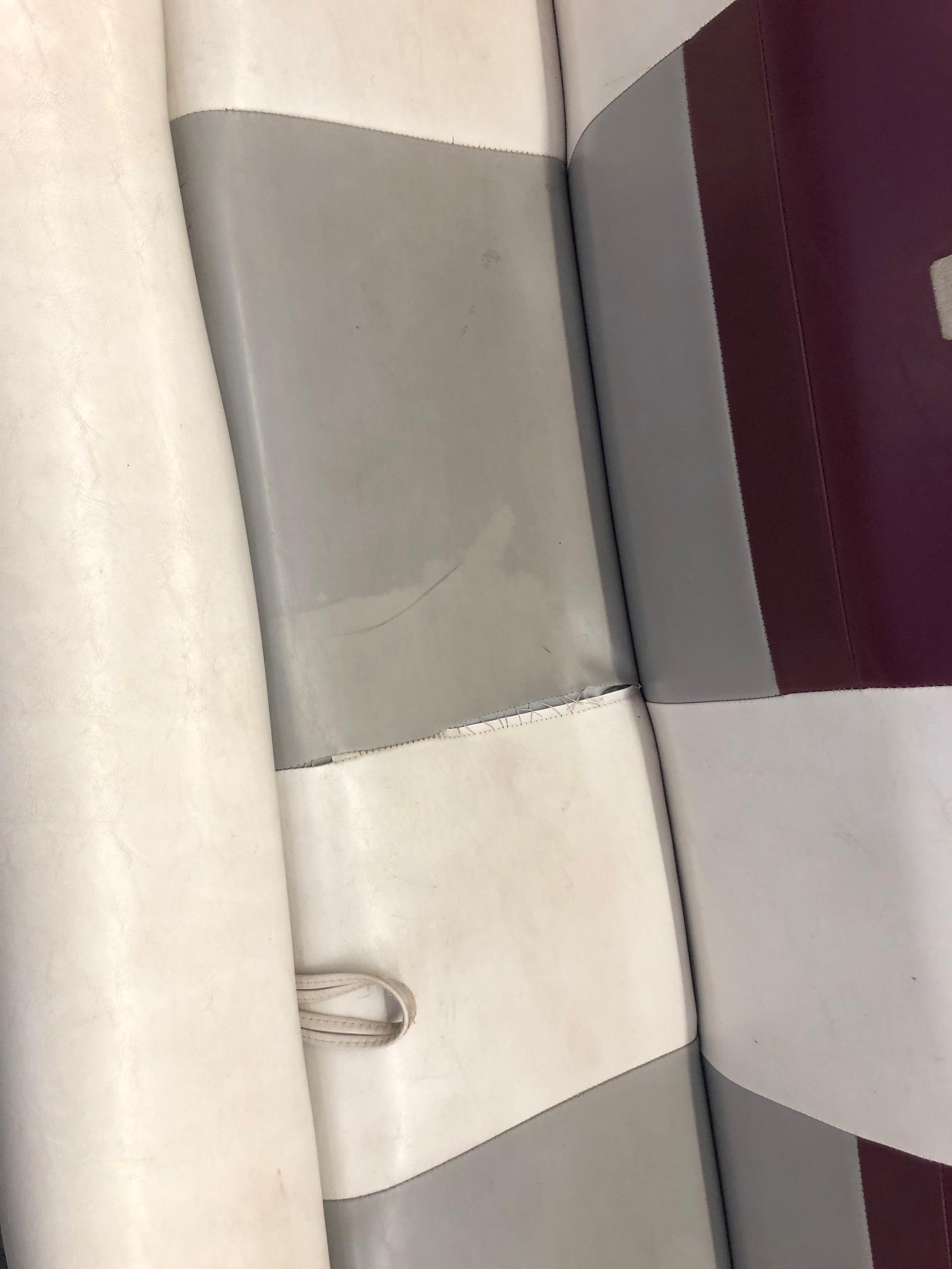 1992 Four Winns 220 Horizon Open Bow boat seat with white, gray, and maroon upholstery.