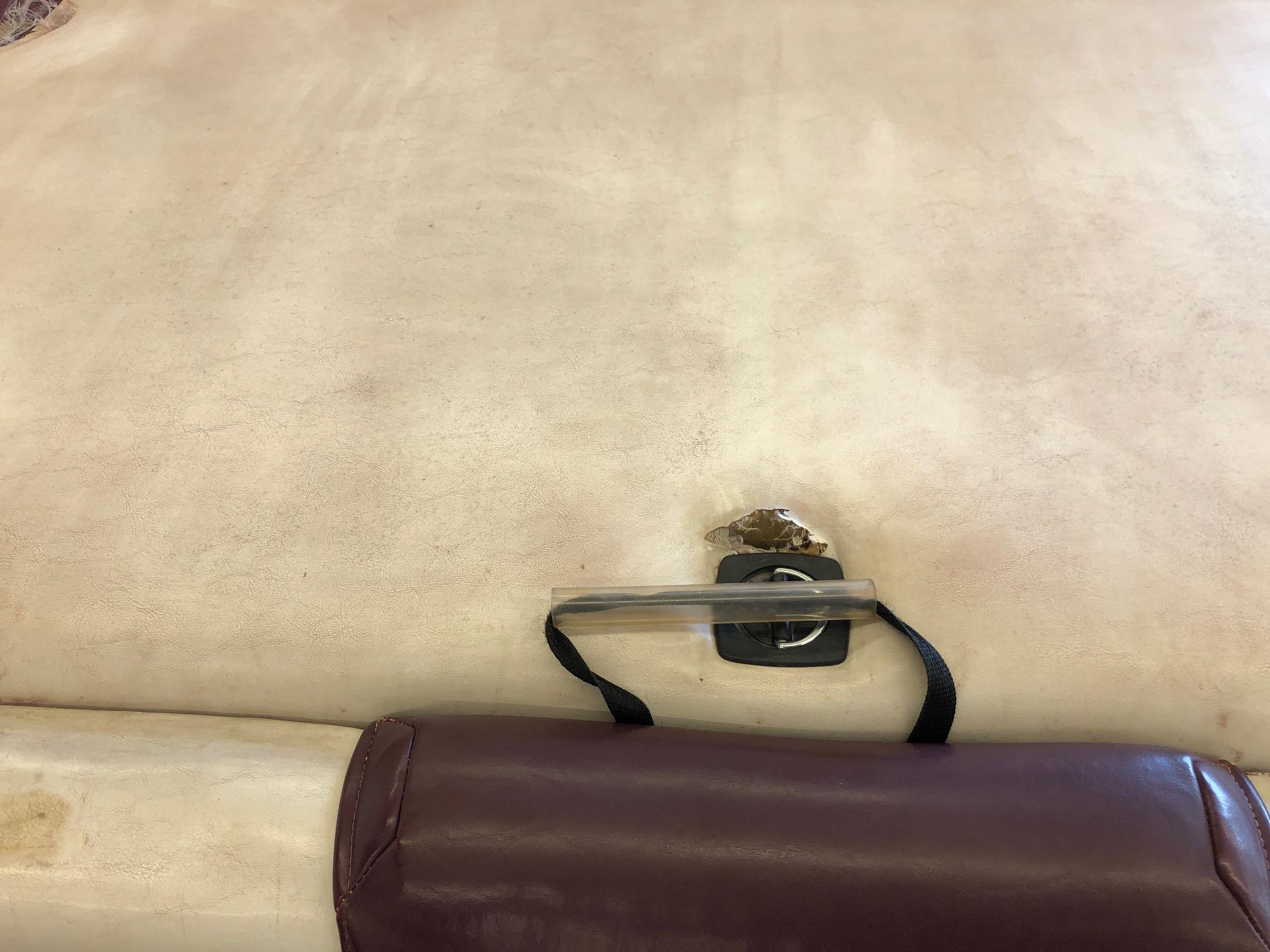 Damaged seat upholstery on a 1992 Four Winns 220 Horizon Open Bow boat.