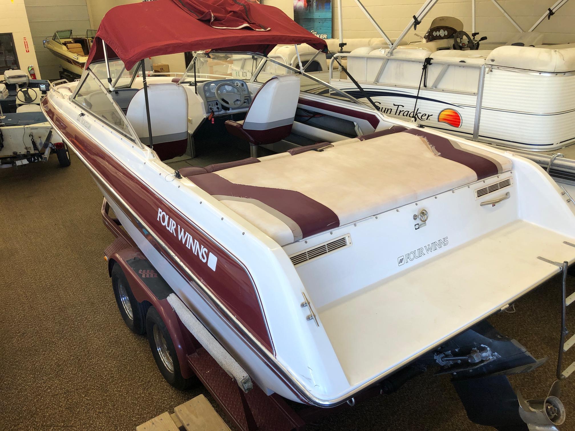 1992 Four Winns 220 Horizon Open Bow boat with maroon and white interior.