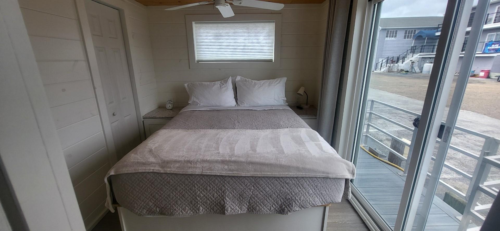 Destination Yachts-16x45 Condo Series 2020 -FL-US-Bedroom interior of 2020 Destination Yachts 16x45 Condo Series with bed and sliding glass door.-9562403 | Thumbnail