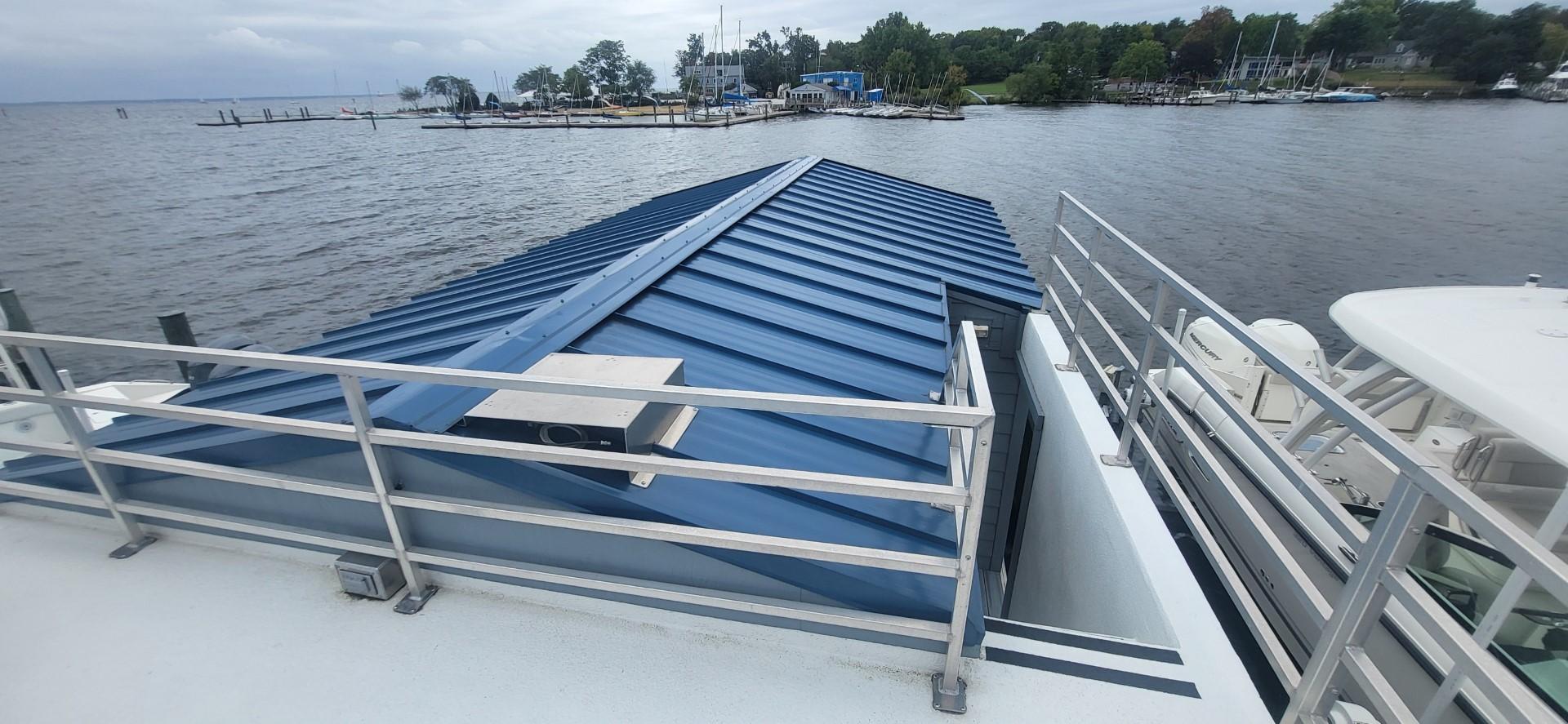 Destination Yachts-16x45 Condo Series 2020 -FL-US-2020 Destination Yachts 16x45 Condo Series houseboat with blue roof on a lake.-9562403 | Thumbnail