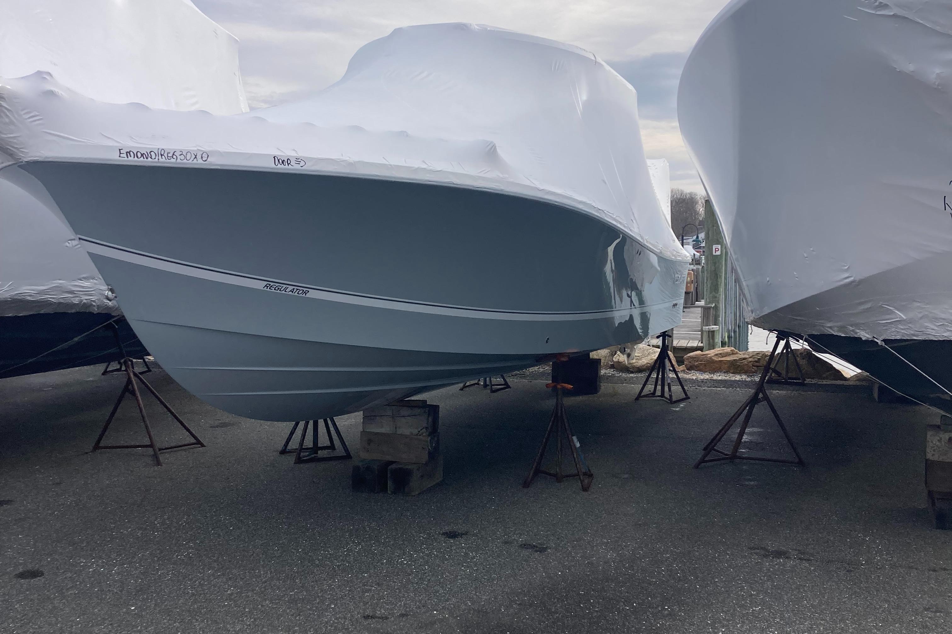 Regulator-30XO 2024-STORM GRAY MA-US-2024 Regulator 30XO boat covered in protective wrap, elevated on stands.-9692464 | Thumbnail