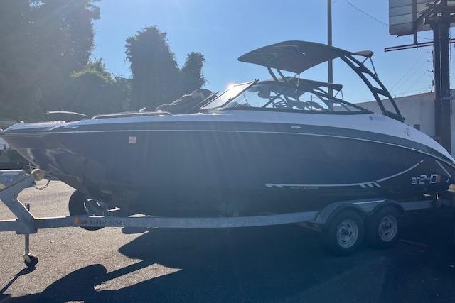 2016 Yamaha Boats AR240 on trailer, side view in sunlight.