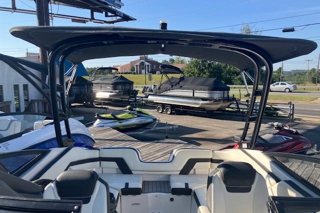 2016 Yamaha Boats AR240 interior view with seating, docked near other boats.
