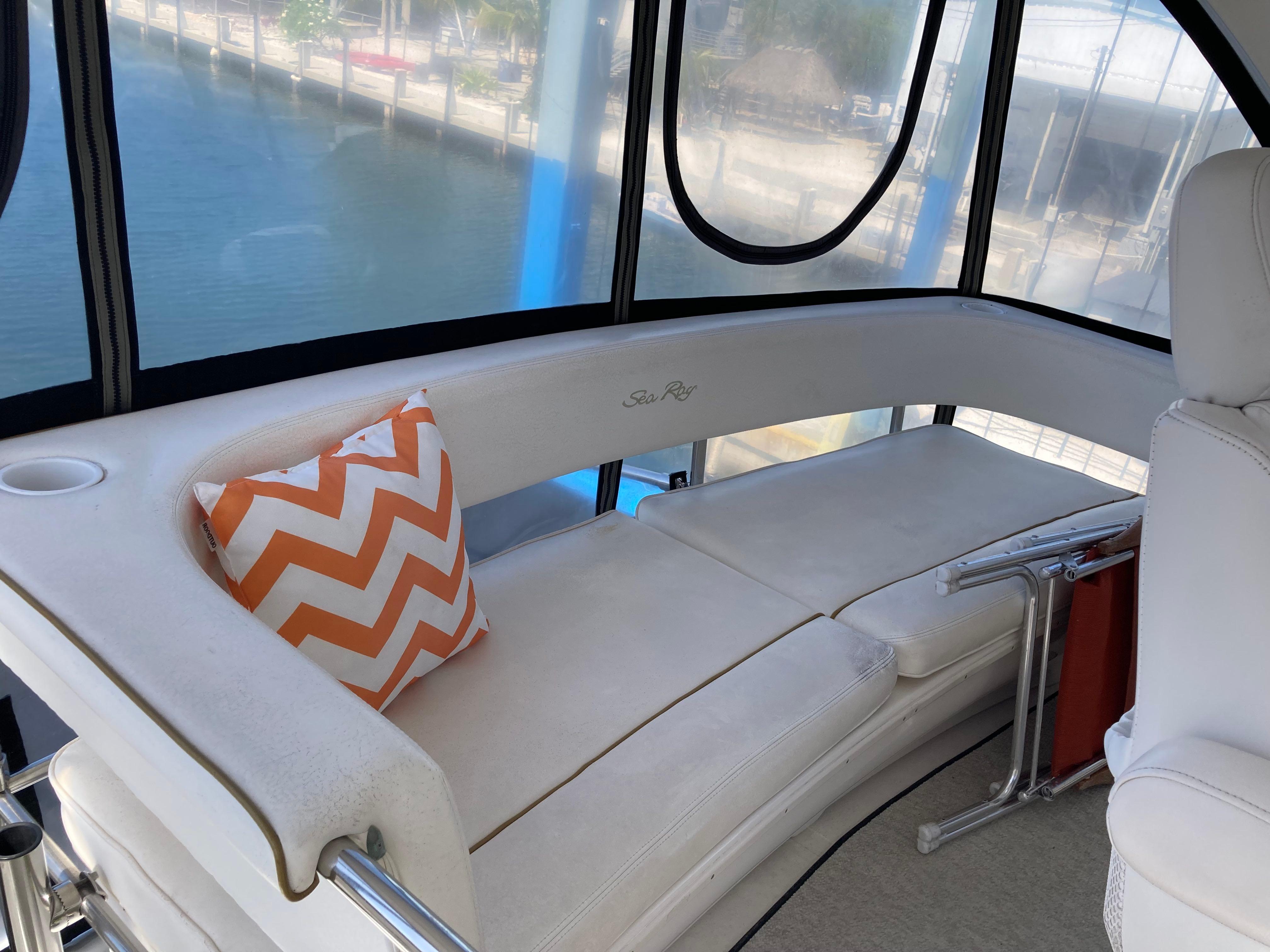 Sea Ray-560 Sedan Bridge 1999-Wade N Winda FL-US-1999 Sea Ray 560 Sedan Bridge interior with white seating and orange chevron pillow.-9842472 | Thumbnail