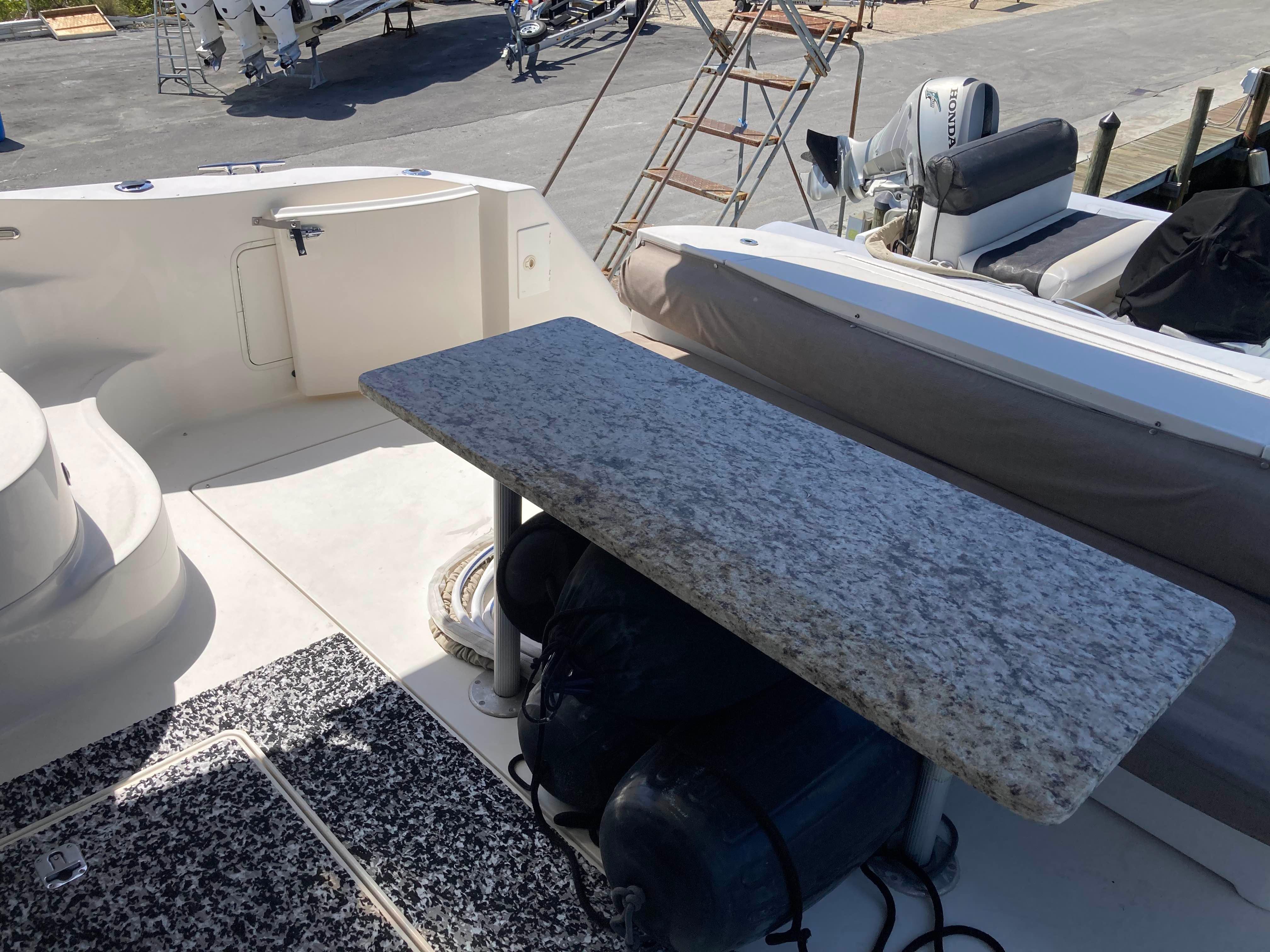 Sea Ray-560 Sedan Bridge 1999-Wade N Winda FL-US-1999 Sea Ray 560 Sedan Bridge yacht deck with granite table and seating area.-9842472 | Thumbnail