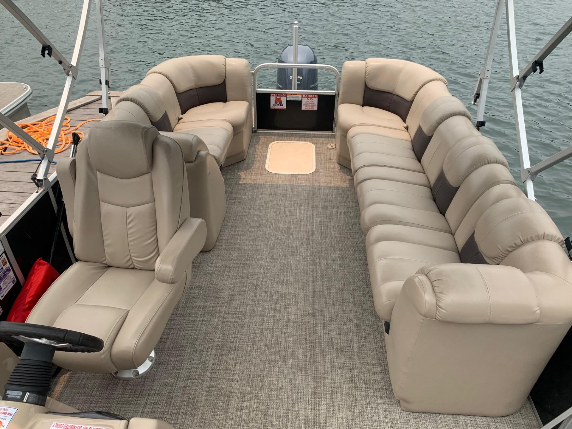 2021 G3 SunCatcher Fusion 325RCX pontoon boat with spacious seating on calm water.