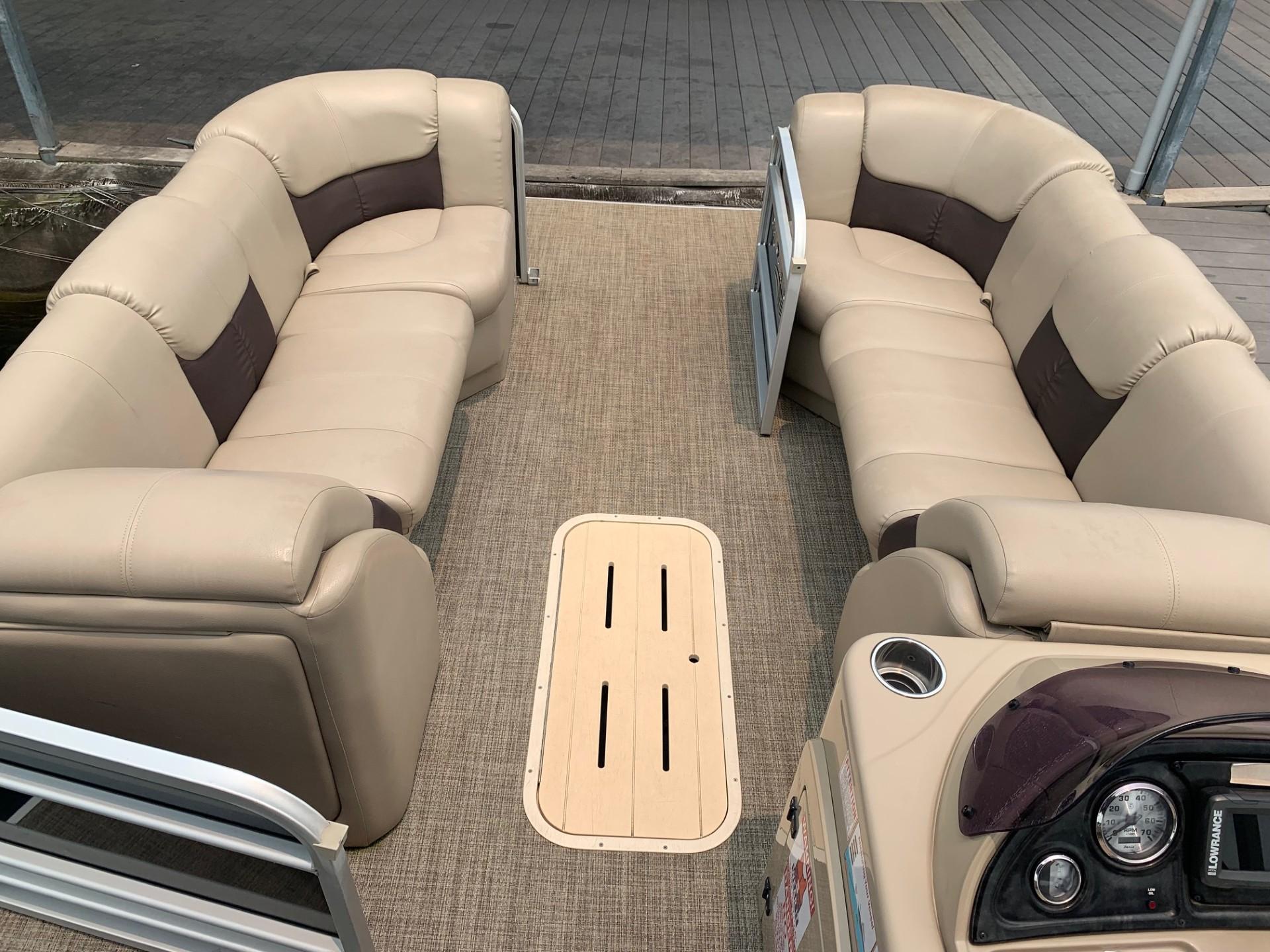2021 G3 SunCatcher Fusion 325RCX pontoon boat interior with beige seating and control panel.