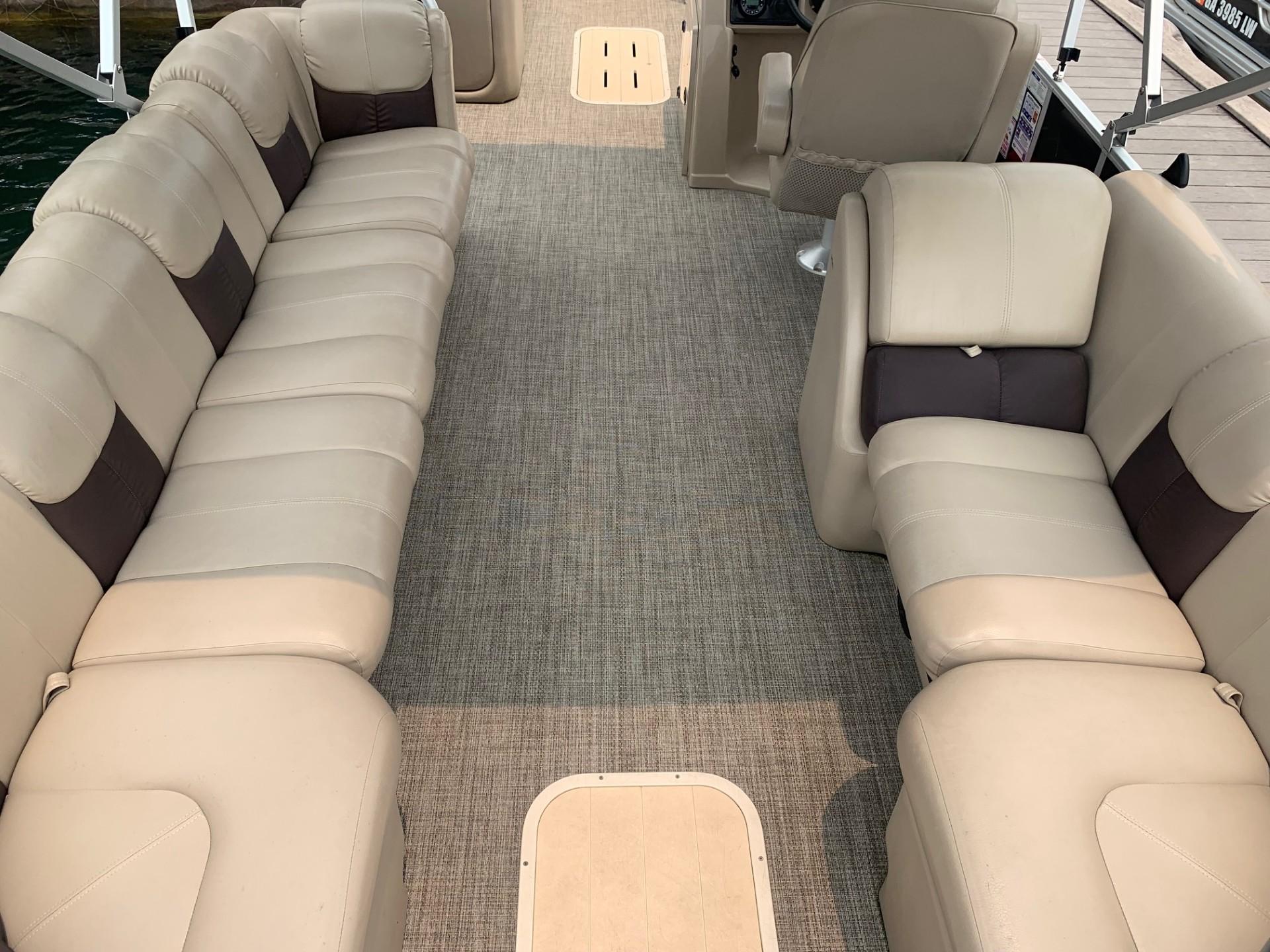 Interior of 2021 G3 SunCatcher Fusion 325RCX pontoon boat with beige seating.