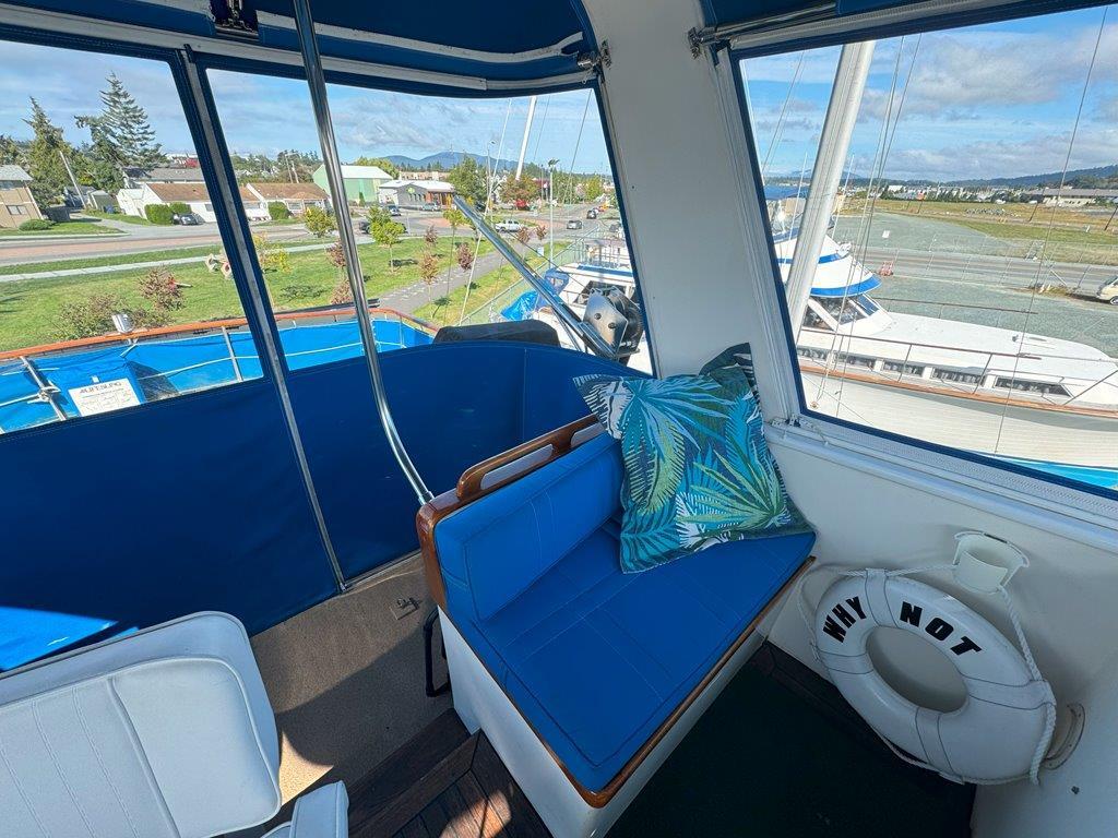 Ocean Alexander-50 MK1 1980 -WA-US-Interior view of 1980 Ocean Alexander 50 MK1 yacht with blue seating and scenic marina backdrop.-9725618 | Thumbnail