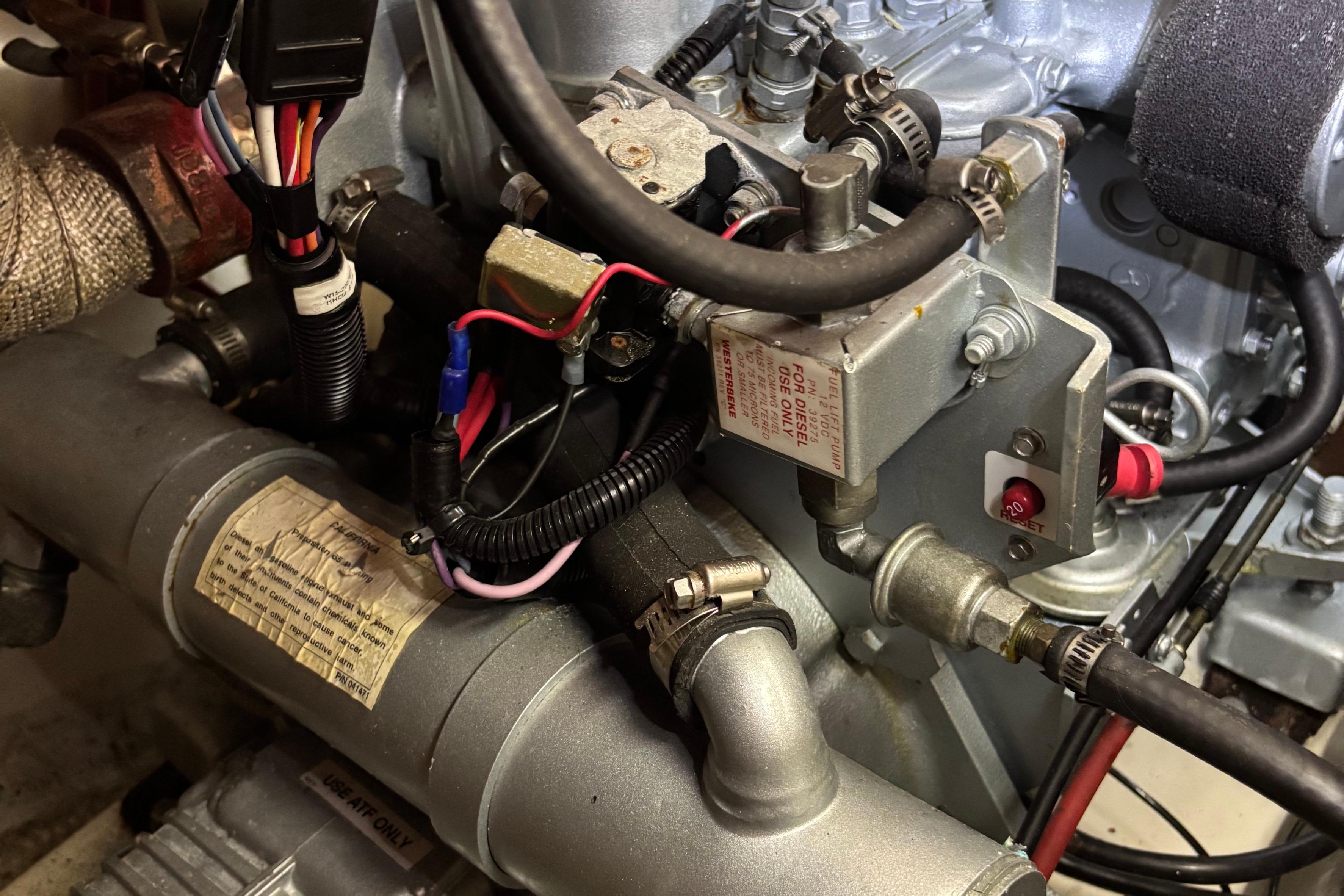 Engine components of a 1981 O'Day 34 sailboat, featuring wiring and fuel system.