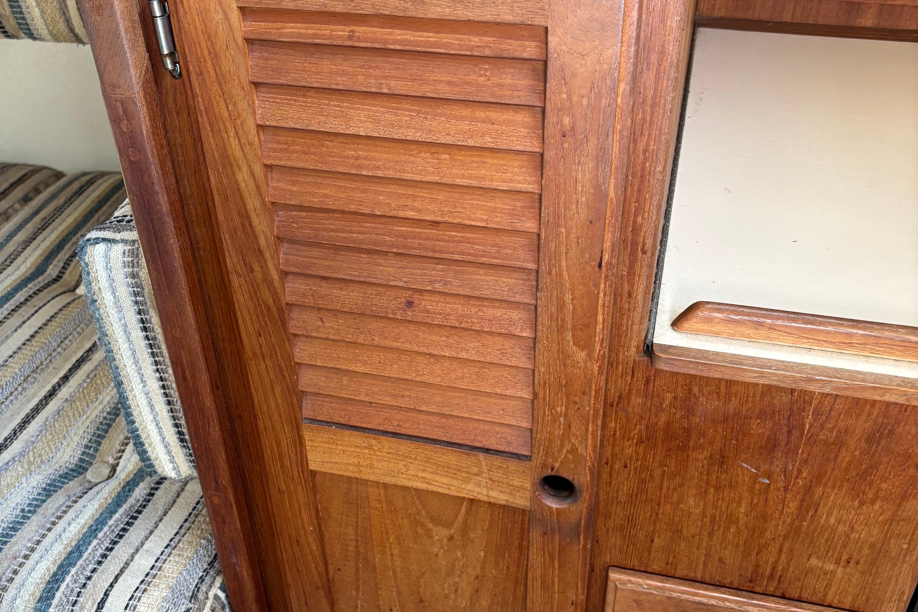 Wooden interior of 1981 O'Day 34 sailboat with striped upholstery.
