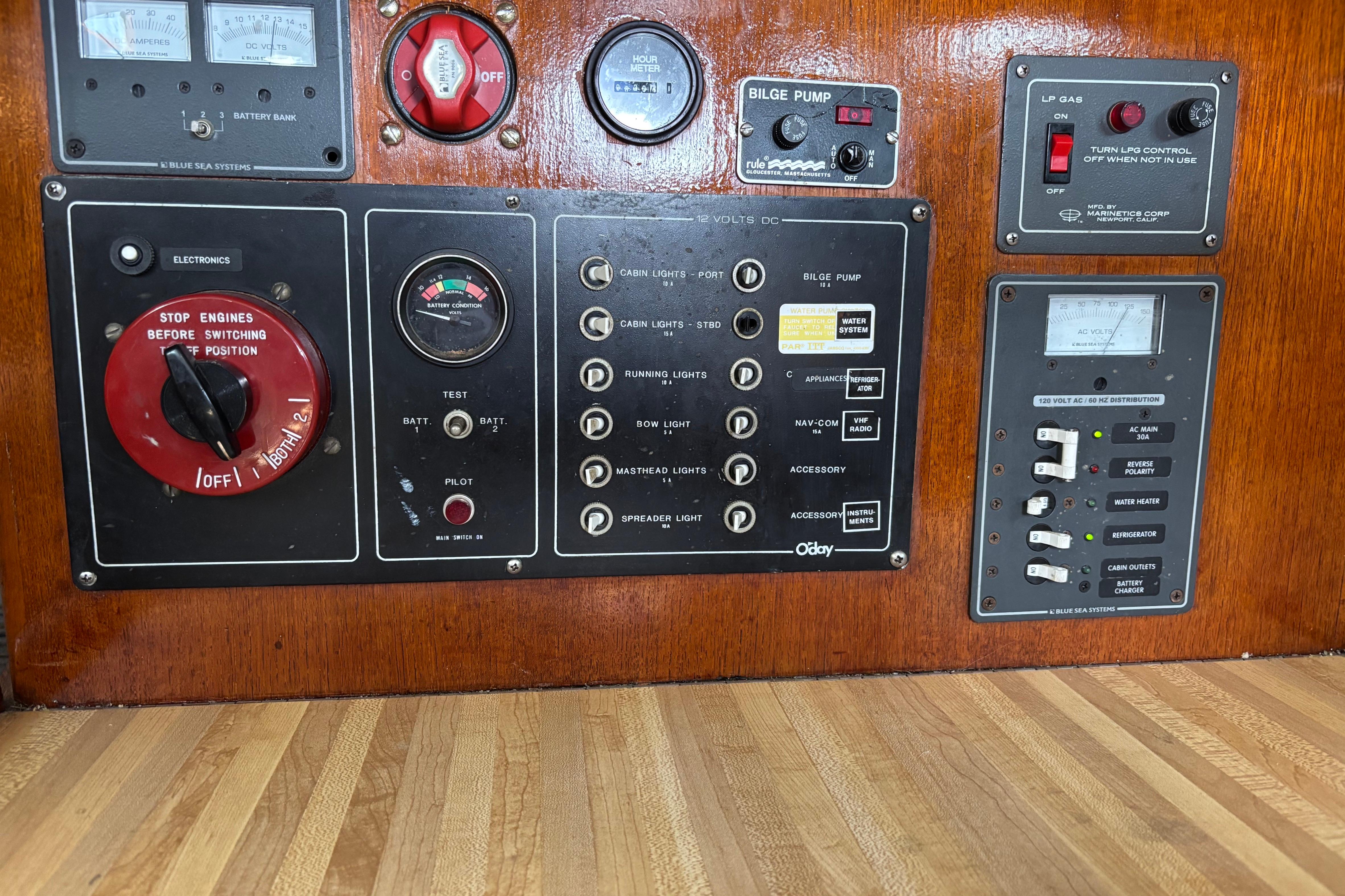 Control panel of a 1981 O'Day 34 sailboat with various switches and gauges.